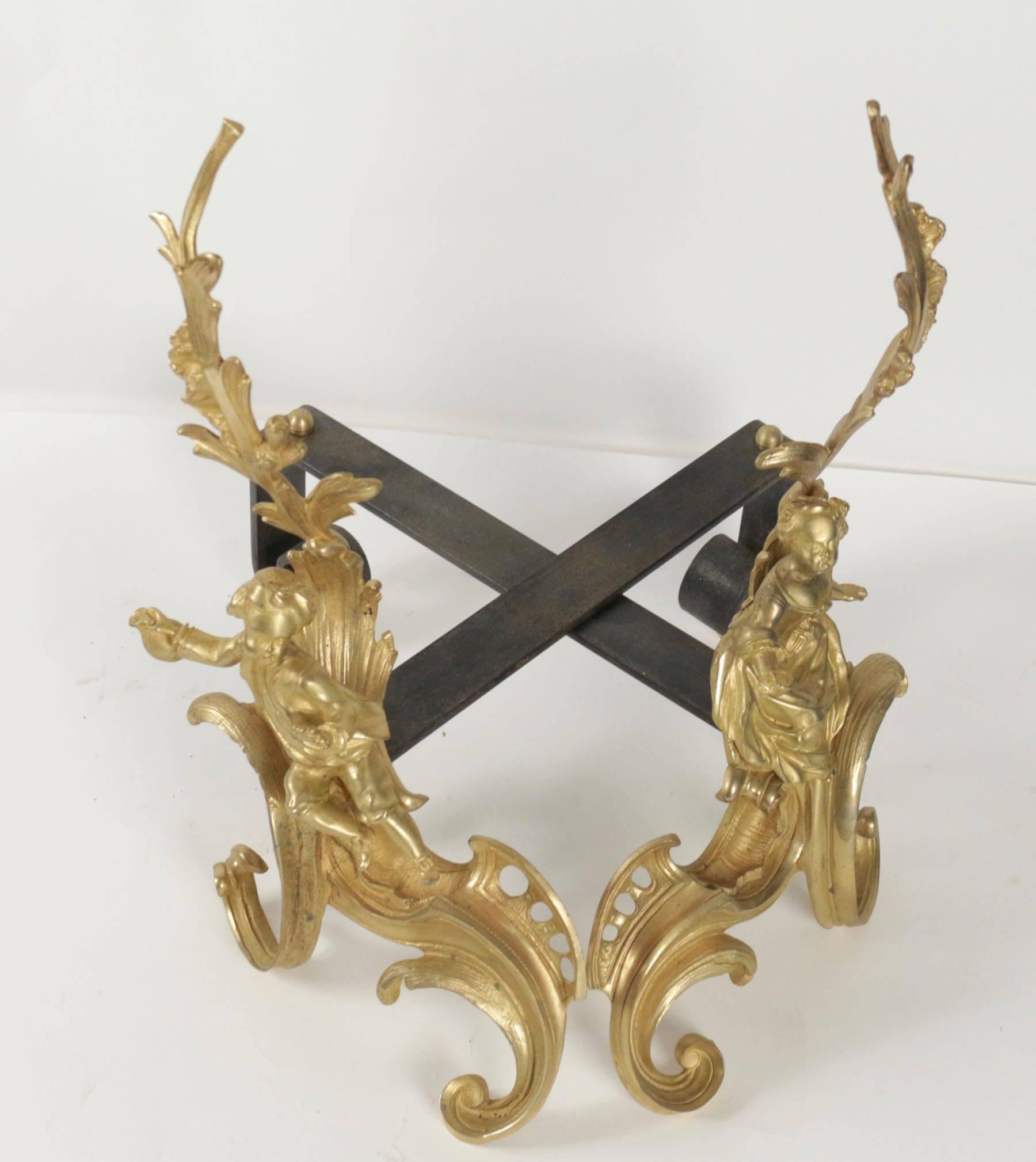 Pair of Louis XV style fireplace irons in gold gilt bronze from the 19th century representing an elegant man and woman, decoration interior design.
 