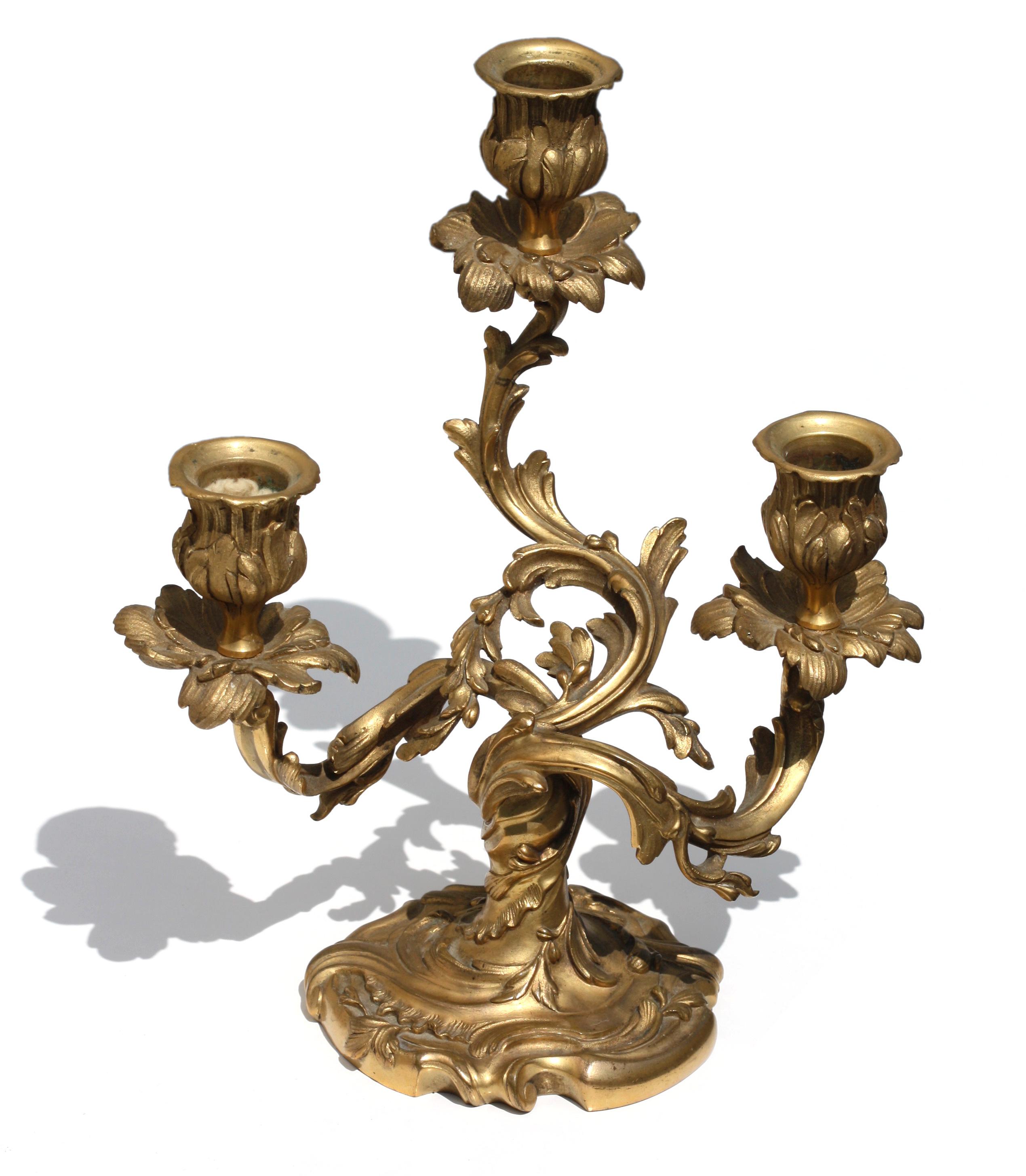 Pair of Louis XV style gilt-bronze three light candelabra
French, 19th century 
Measures: Height 10 in. (25.4 cm.) 
Width 8.5 in. (21.59 cm.).
  