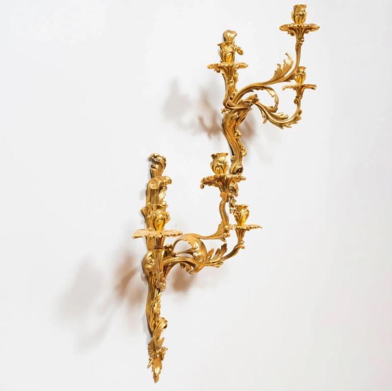 Zwei dreiflammige Wandleuchter aus vergoldetem Metall im Louis-XV-Stil (Louis XVI.) im Angebot