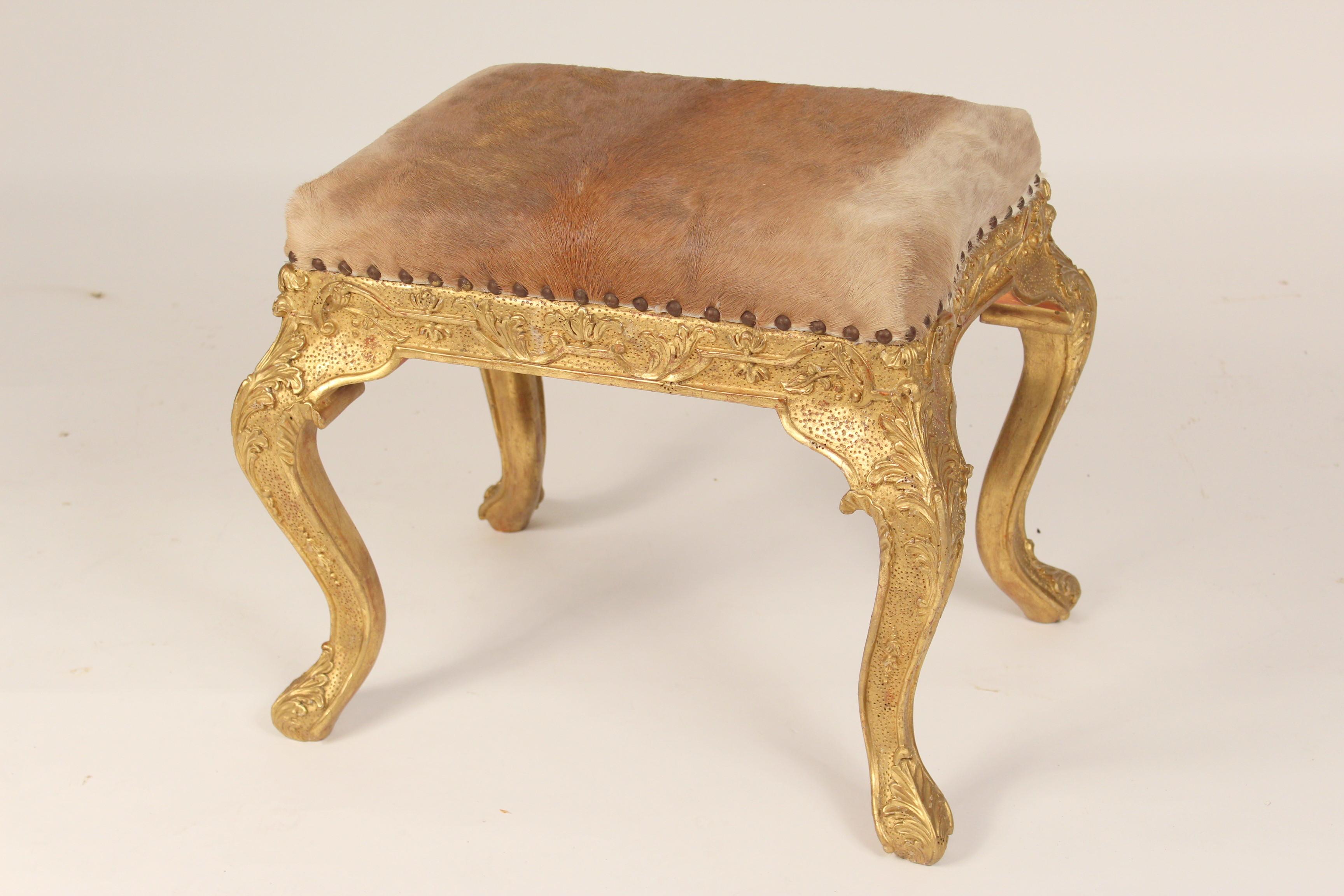 Pair of Louis XV style gilt wood benches (gold leaf) with cow hide upholstered seats, late 20th century. Seat dimensions, width 22