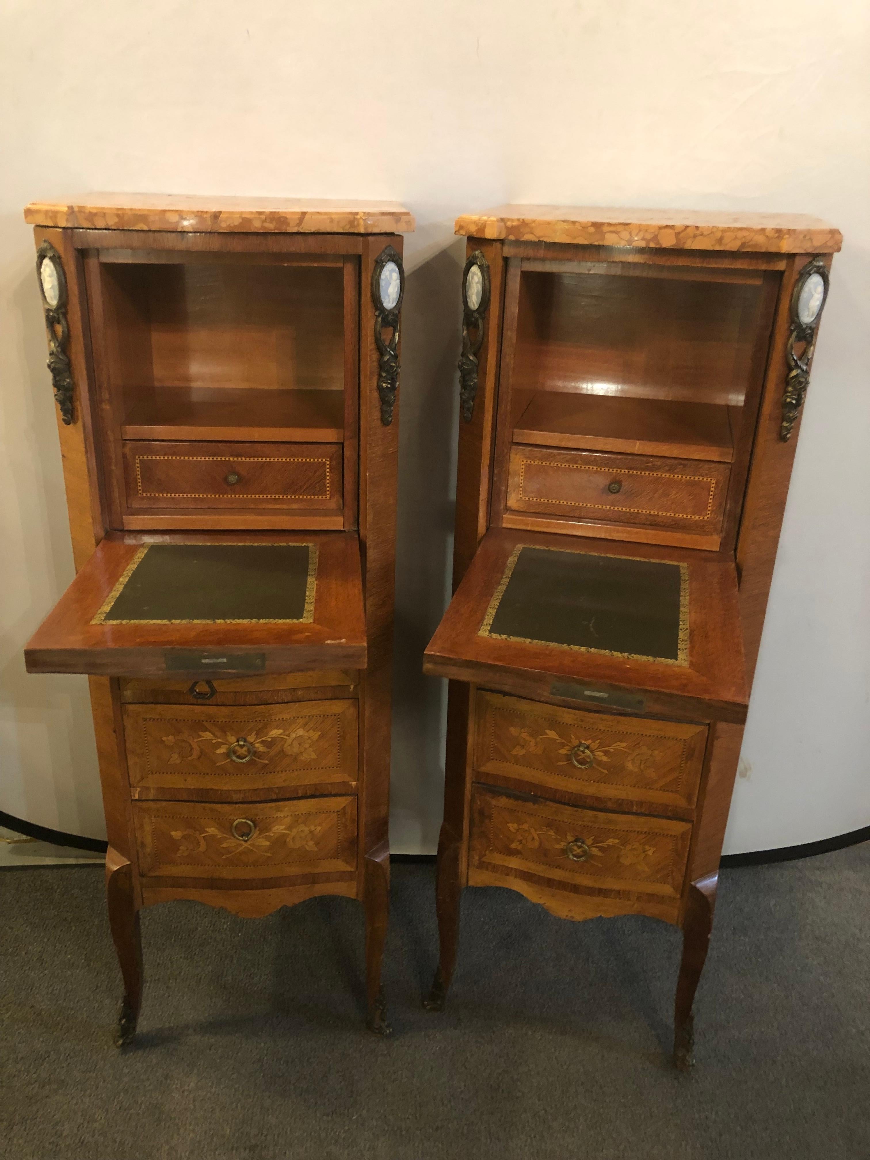 Pair of Louis XV style inlaid secretaries a abattant having rouge marble tops with fall front writing boards. These wonderful late 19th or early 20th century lingerie chests each have three finely floral inlaid drawer fronts under a pull down desk