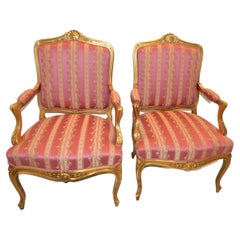 Pair of Louis XV style leaf gilded armchairs, pink stripe and print upholstery.