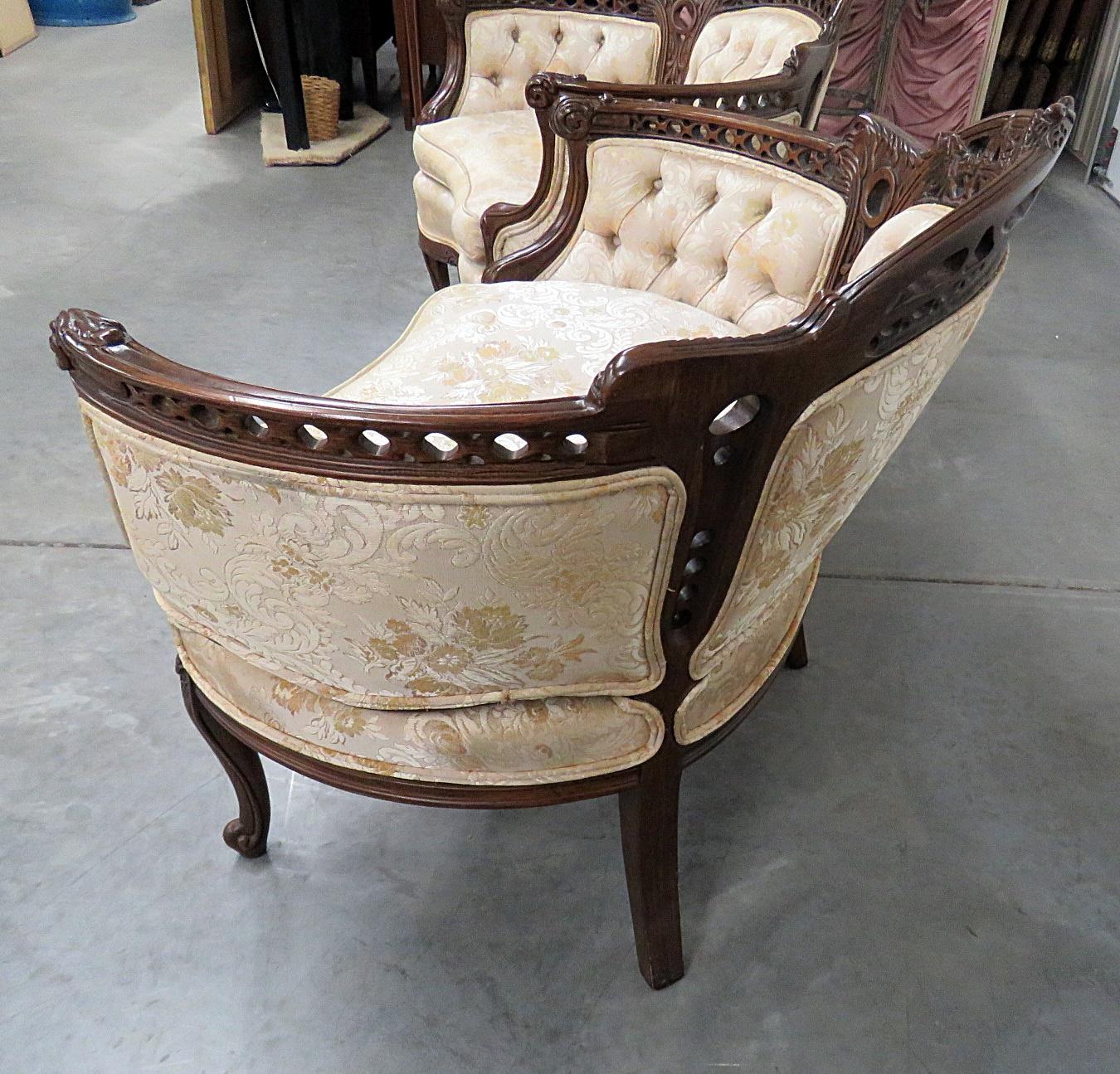 Pair of Louis XV style marquis with textured upholstery and tufted backs and sides.