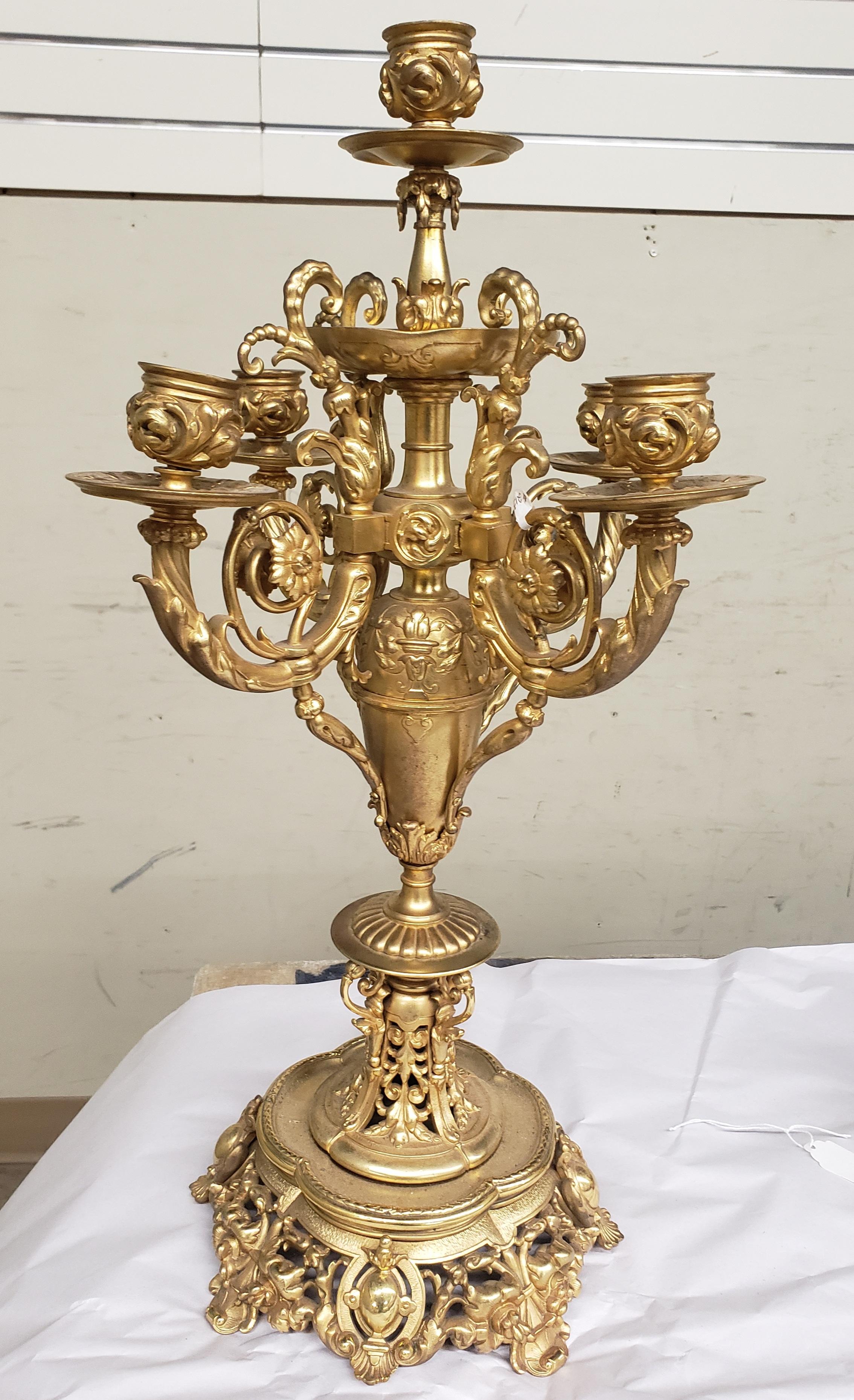 A striking and high quality pair of French 20th century Louis XV st. ormolu candelabras. Each five arm candelabra is raised by a beautiful pierced base with a scalloped octogonal shape, fine scrolled foliate feet, beautiful central leaf and