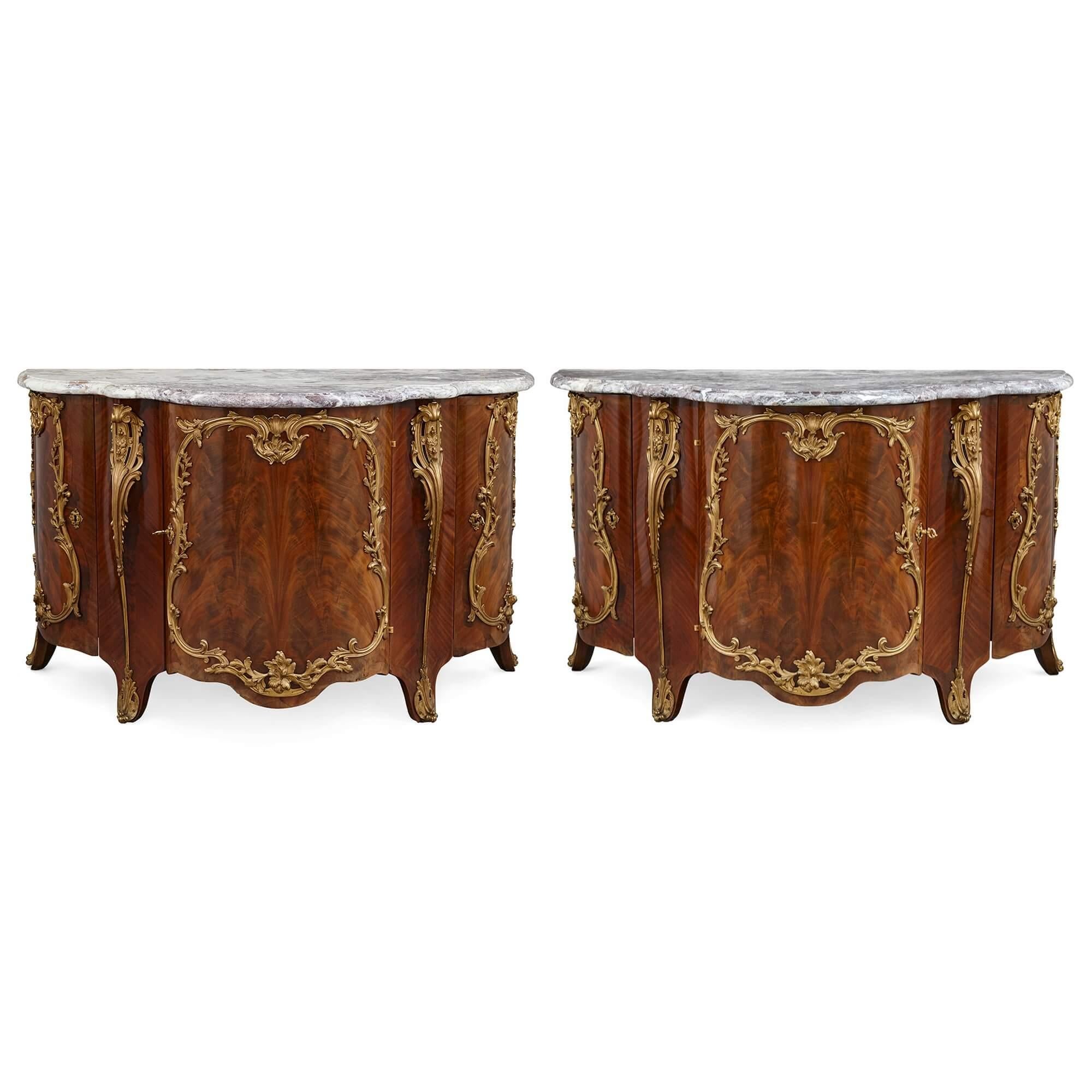 Pair of Louis XV style ormolu-mounted mahogany and marble commodes.
French, 19th Century
Measures: Height 82 cm ,width 134 cm ,depth 59 cm.

These remarkable pieces, large, and of rare and unusual design, are an excellent pair of Louis XV style
