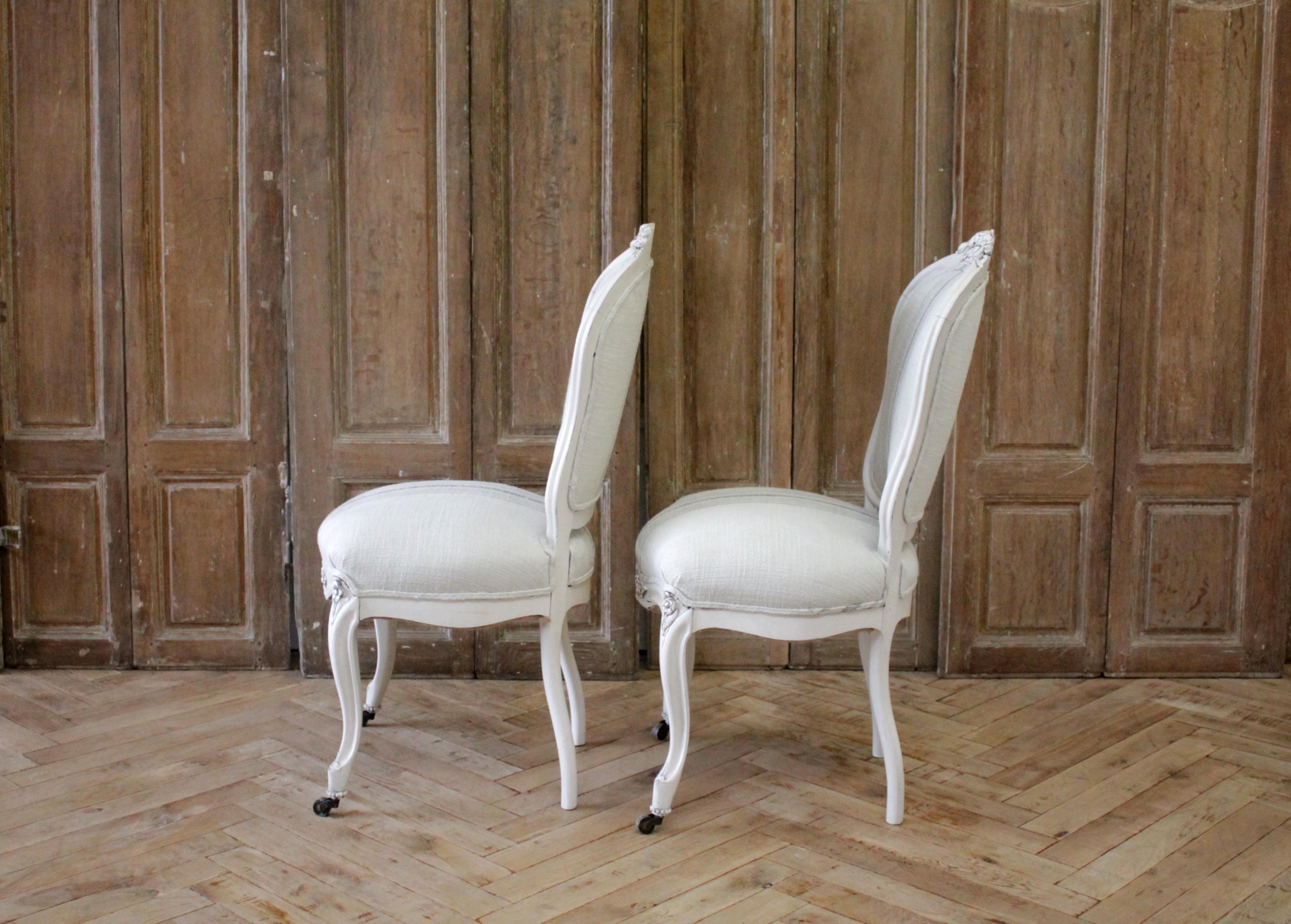 Pair of Louis XV style painted and upholstered side chairs
Painted in a soft oyster white finish with subtle distressed edges and antique patina. We reupholstered these in a thick nubby soft linen blend, with gray and olive stripes.
Chairs are