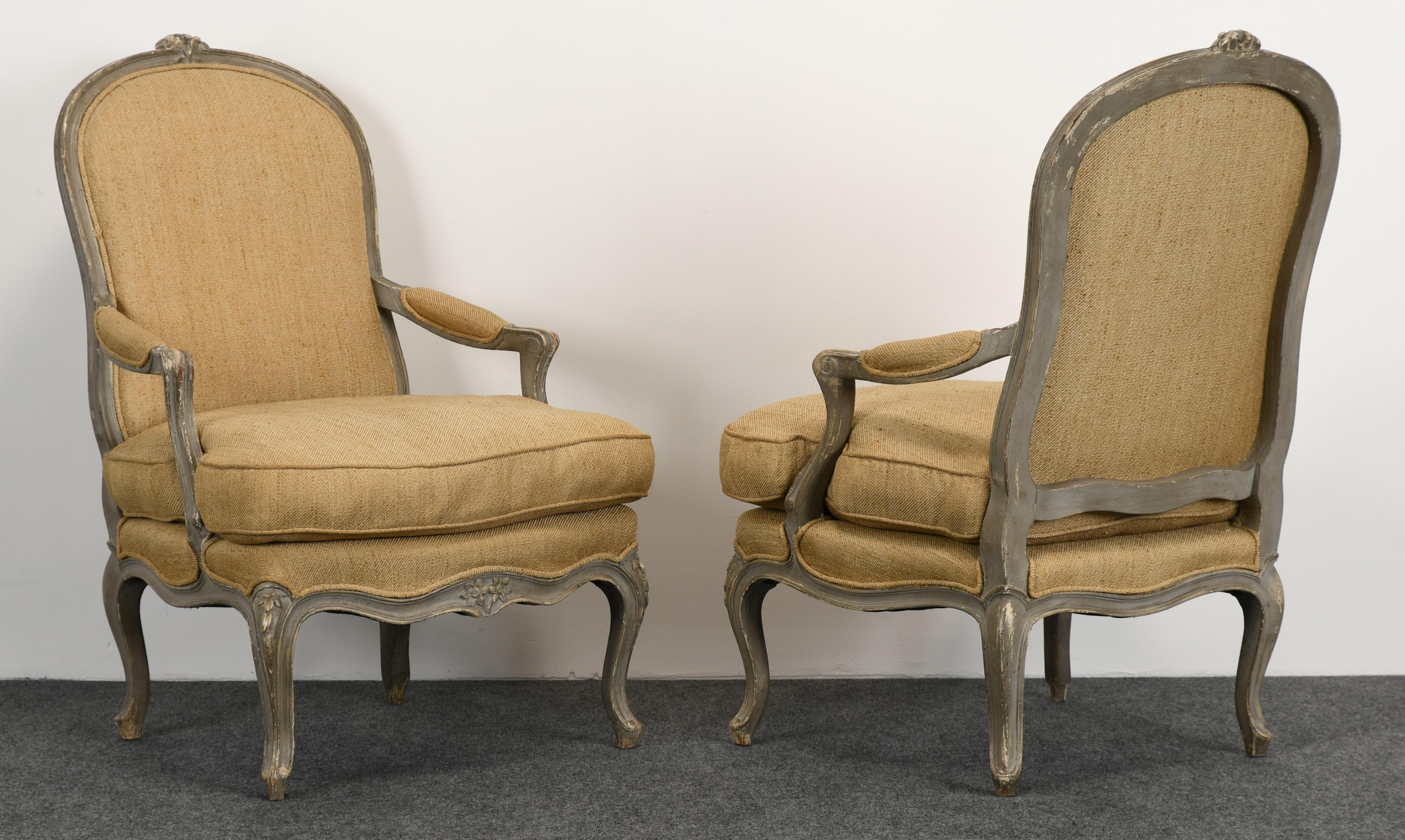 A wonderful large scale pair of painted Louis XV style chairs with Gustavian grey finish. Newer upholstery, however, some spots to the underside of cushions. Great patina with a distressed painted finish. Frames are structurally sound with cushion