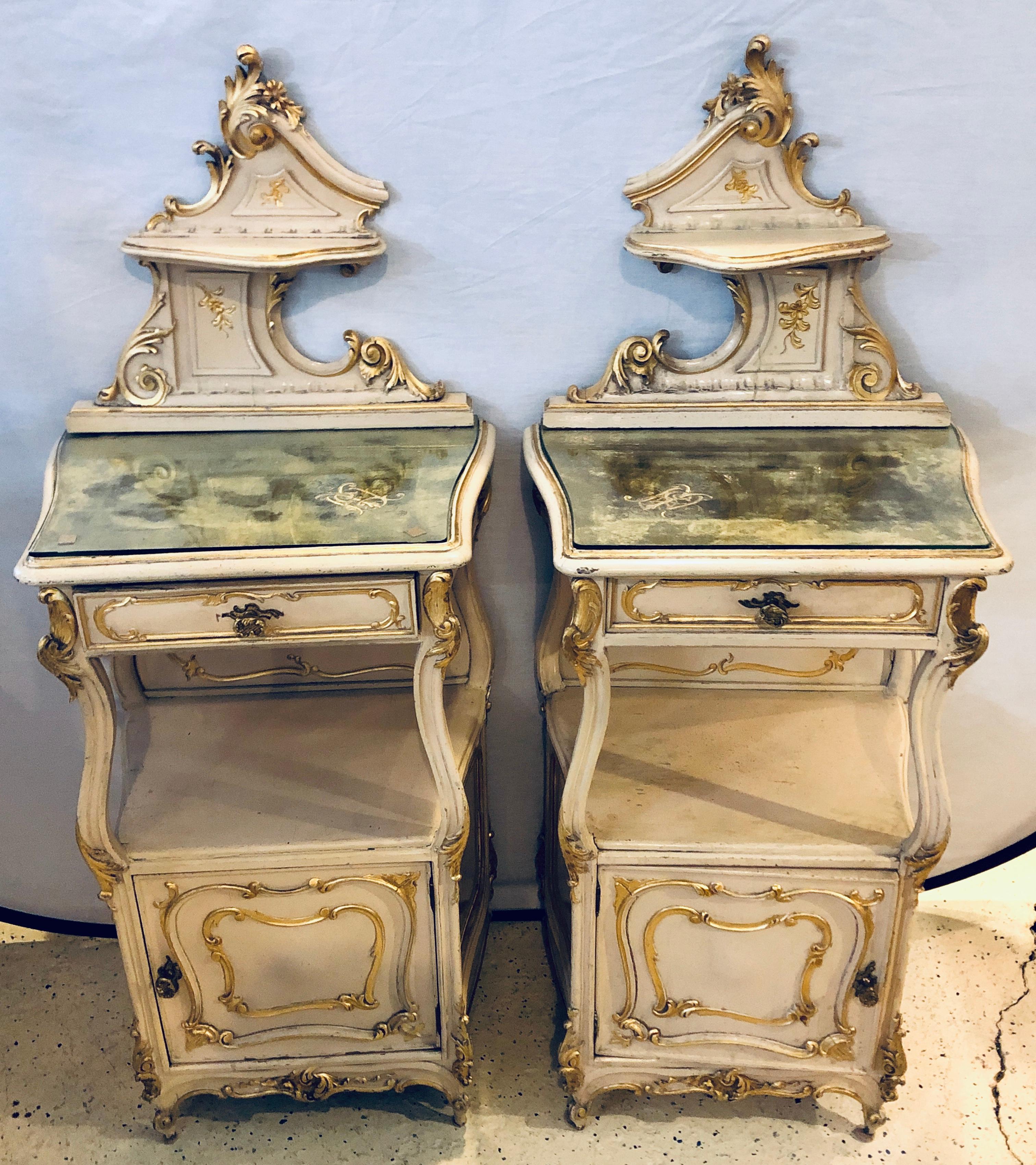 Pair of Louis XV style painted cabinets, nightstands or end tables. These finely constructed parcel gilt decorated and painted cabinets can be used in most any room of the home as they sit as nightstands, sofa tables, end tables or pedestals. The