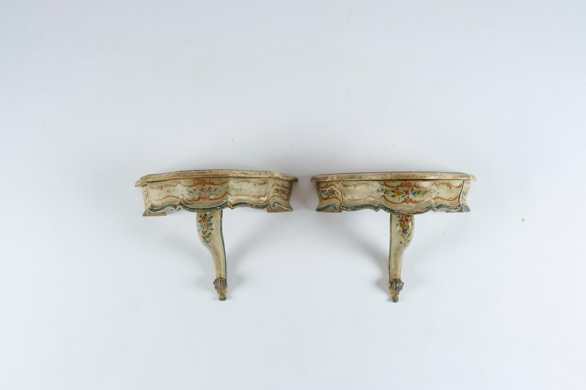 A 20th century carved wall shelves, each with one-drawer and lovely hand painted floral detail.
