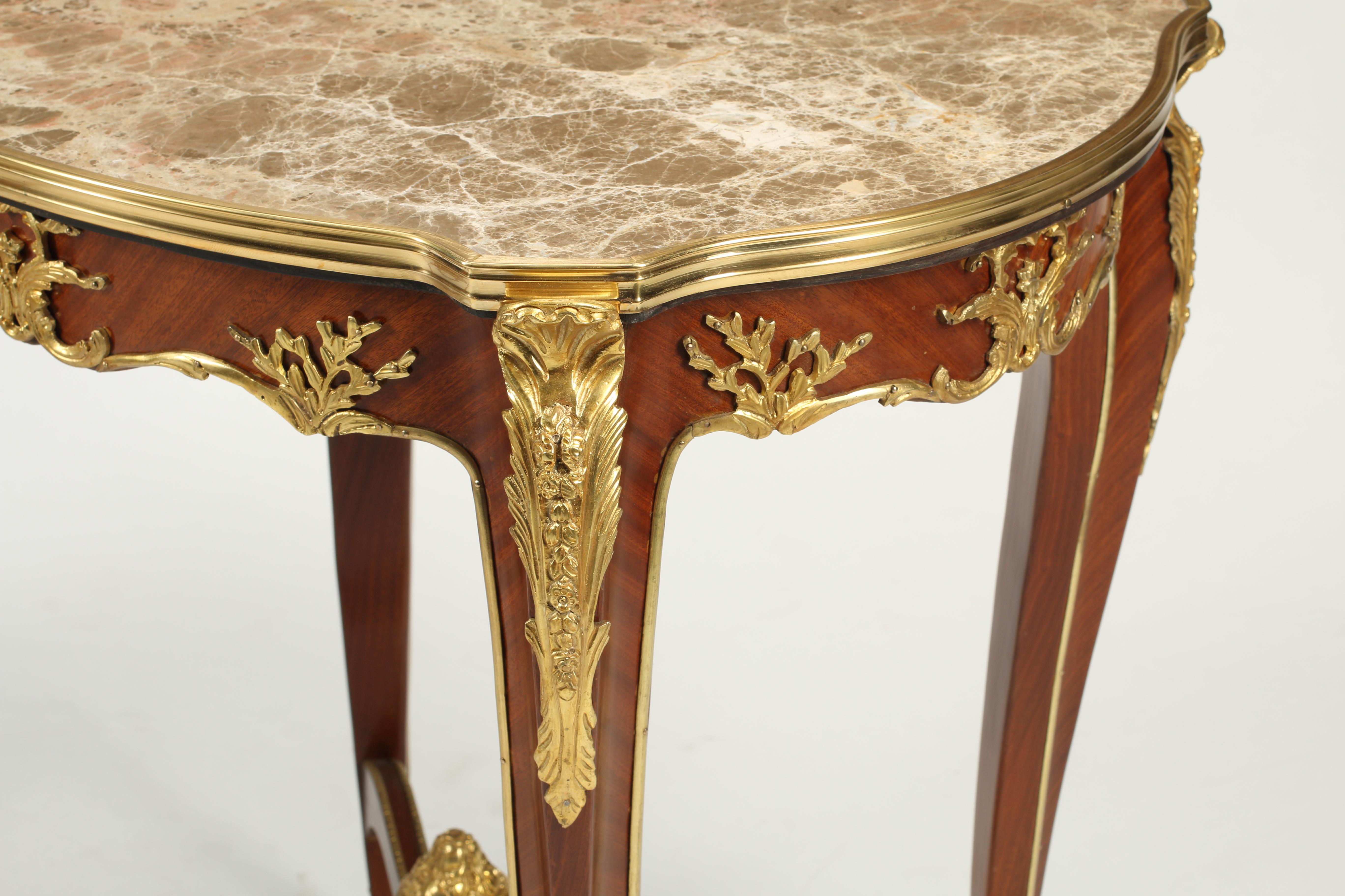 Attractive pair of French Louis XV style kingwood veneered side tables with gilt bronze mounts and marble inset tops. Stretchers centered with a bronze urns. 

The pair of tables are highly decorative.