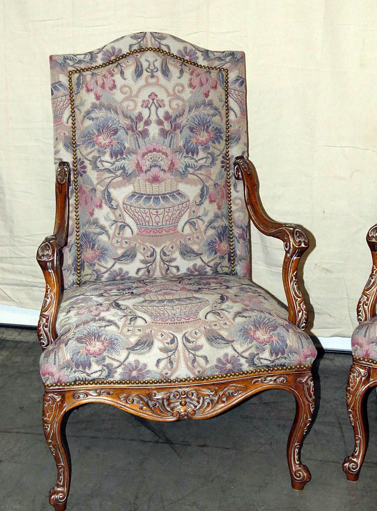 Pair of Louis XV style armchairs with machine upholstery and nailhead trim.