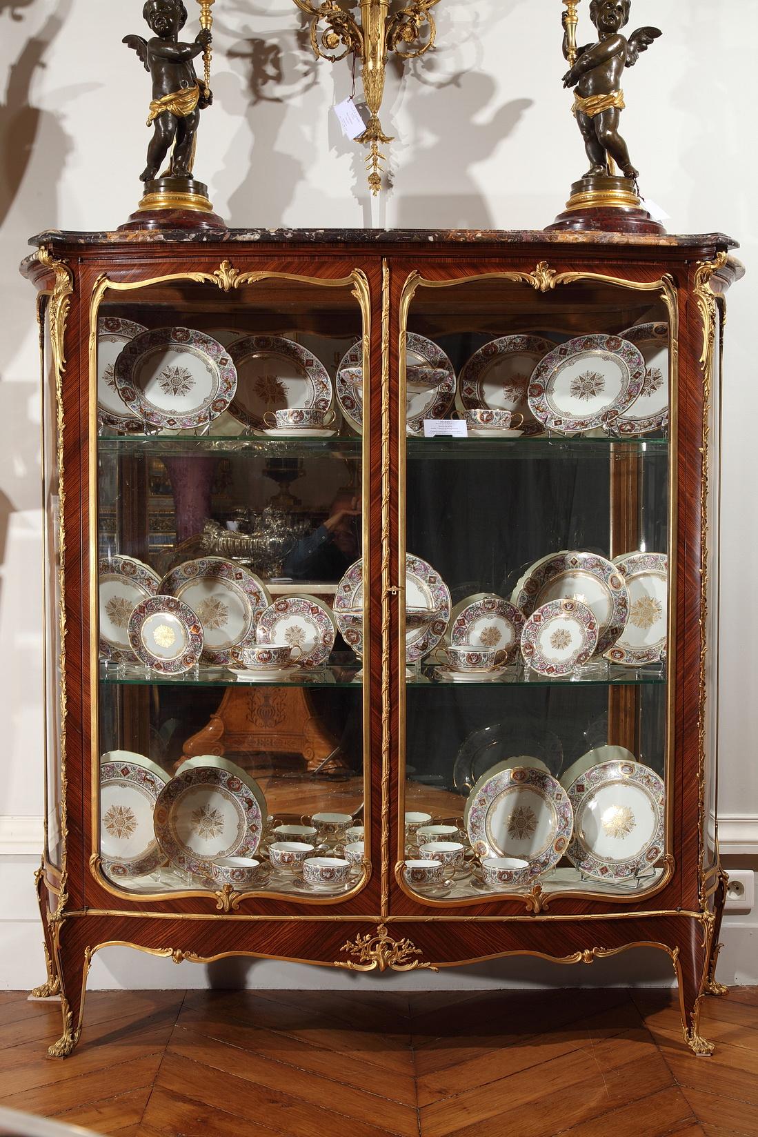 Rare pair of Louis XV style gilt-bronze mounted curved shape vitrines attributed to J.E Zwiener. Glazed on all sides, they open with two doors framed by gilded and chiseled Rocaille style foliated bronze mounts. Resting on four cabriole legs ending
