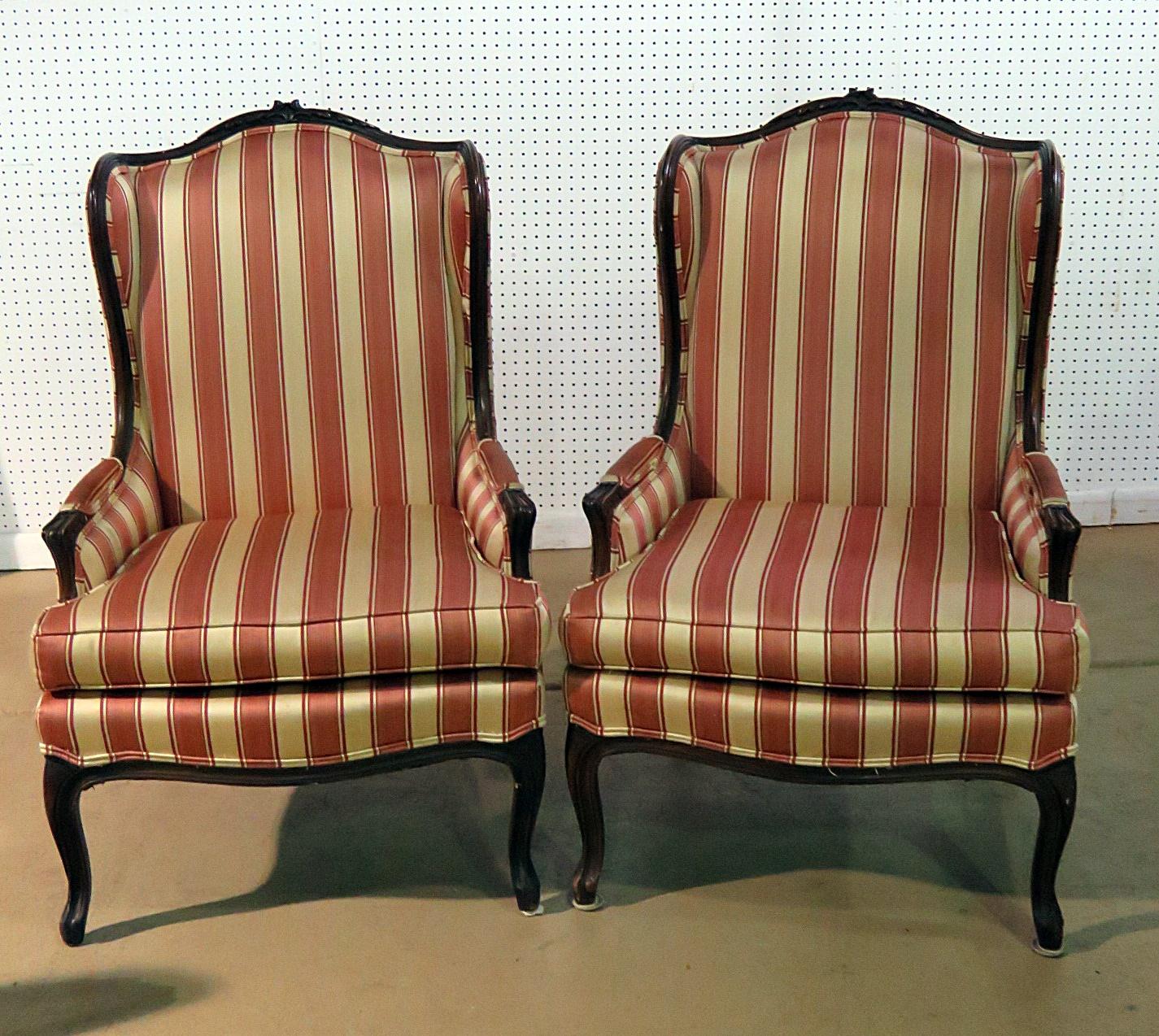 Pair of Louis XV style wingback chairs with striped upholstery.