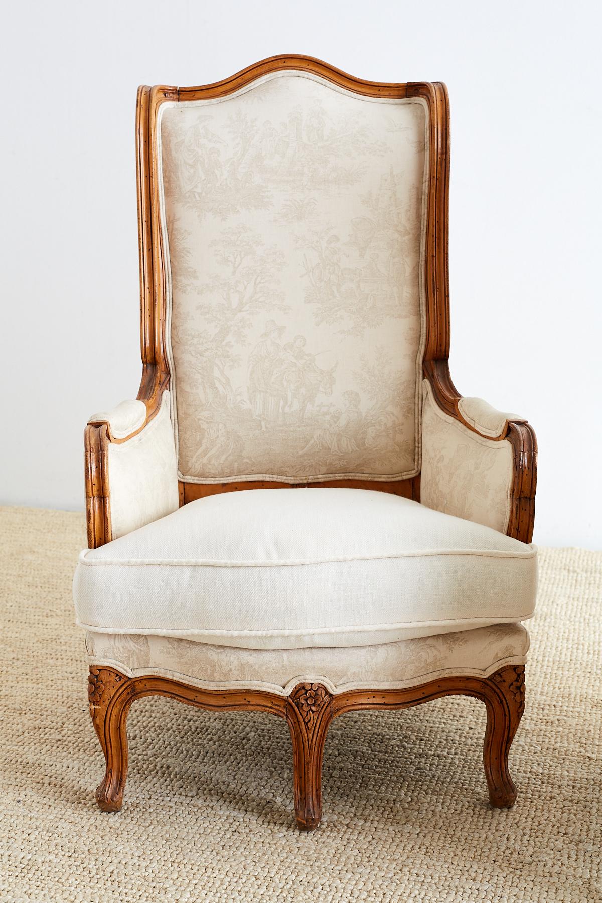 Charming and rare pair of five-legged French bergeres styled after the Louis XV taste during the Napoleon III period. Featuring a toile de jouy upholstery depicting French country life. The frames showcase a unique whimsical craftsmanship with small