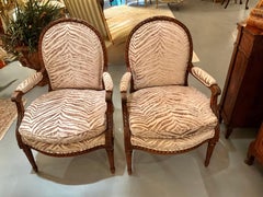 Pair of Louis XVI arm chairs with oval backs and reeded legs