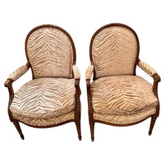 Pair of Louis XVI arm chairs with oval backs and reeded legs