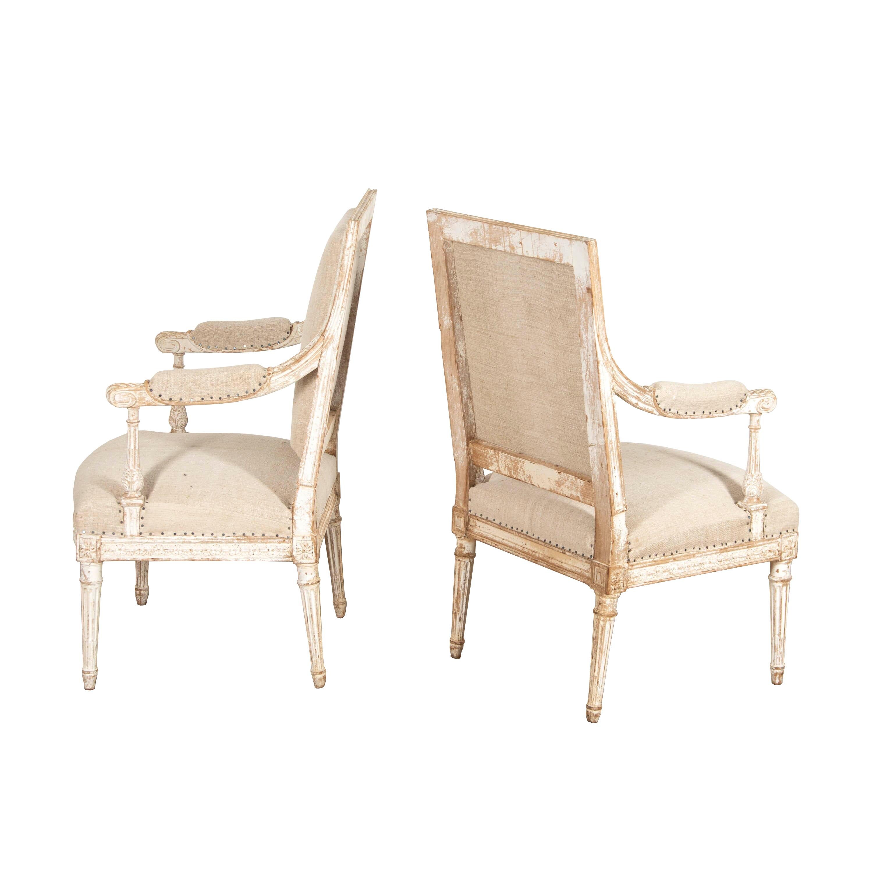 Elegant pair of Louis XVI armchairs.
Featuring superb, refined carving throughout with traces of original paintwork. Both chairs have been beautifully crafted from wood, with comfortable seats and a strong structure. 
Raised on tapered, round legs