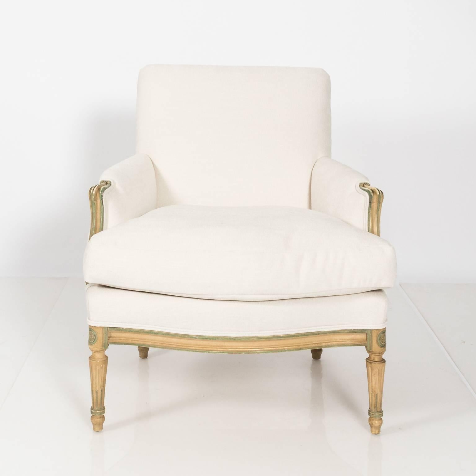 Pair of Louis XVI bergere chairs freshly upholstered in a white linen blend fabric with feather down cushions, circa 1930.
 