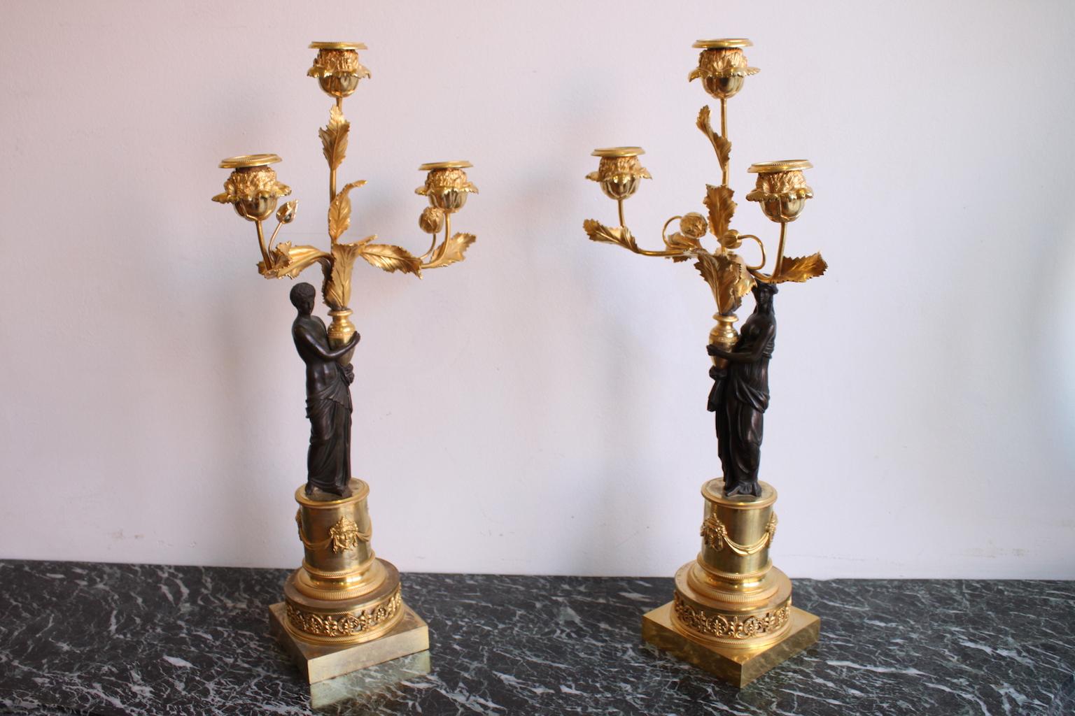 Pair of Louis XVI candlesticks in bronze gilded with mercury, representing antique woman and man, and decorated with masks and roses. Gold patina with mercury and medal patina.
In a perfect state.
Dimensions: Total height 50cm. Total width 23cm.