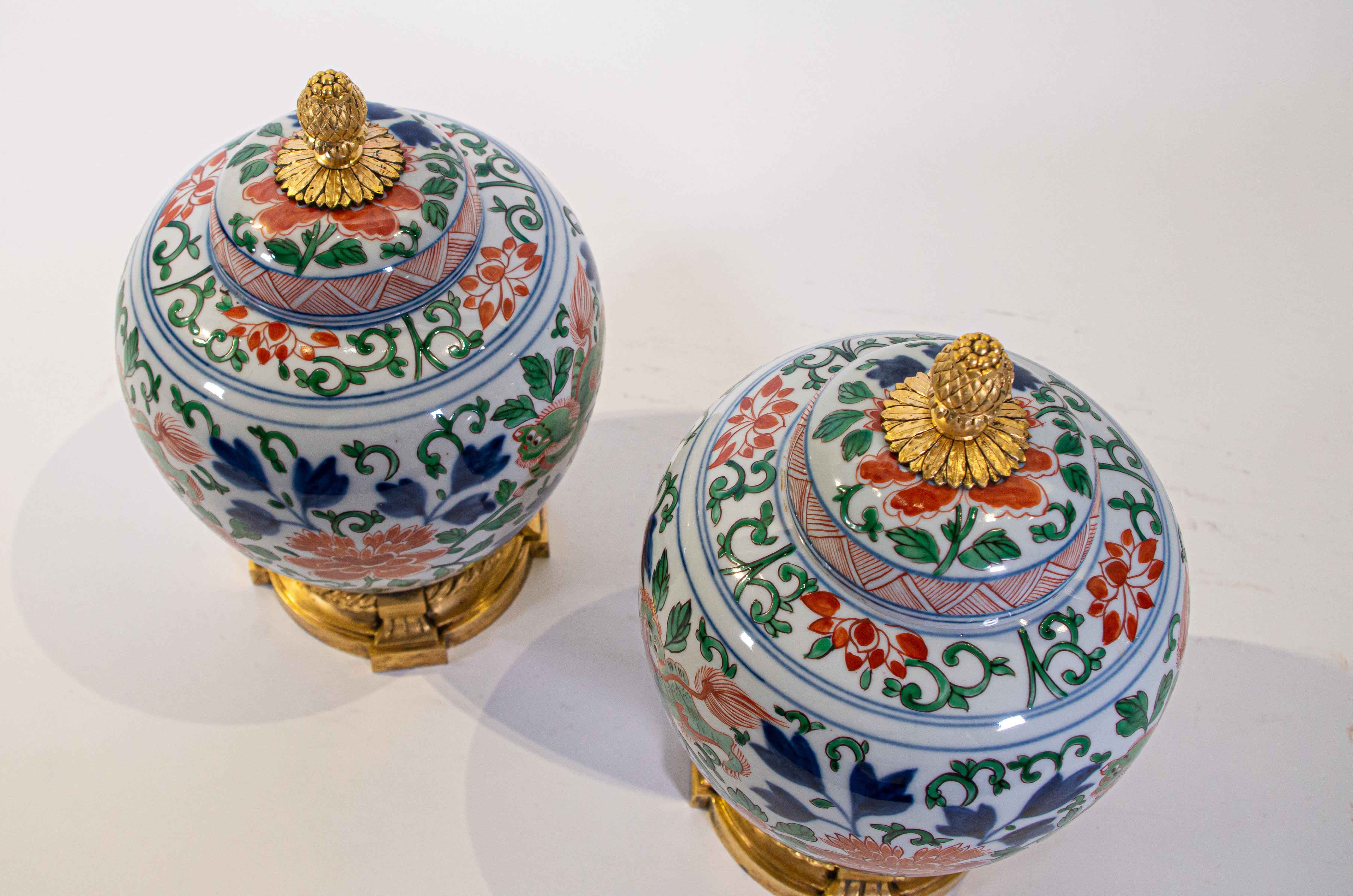 Early 19th Century Pair of Louis XVI Dore Bronze Mounted Chinese Porcelain Wucai Covered Urns