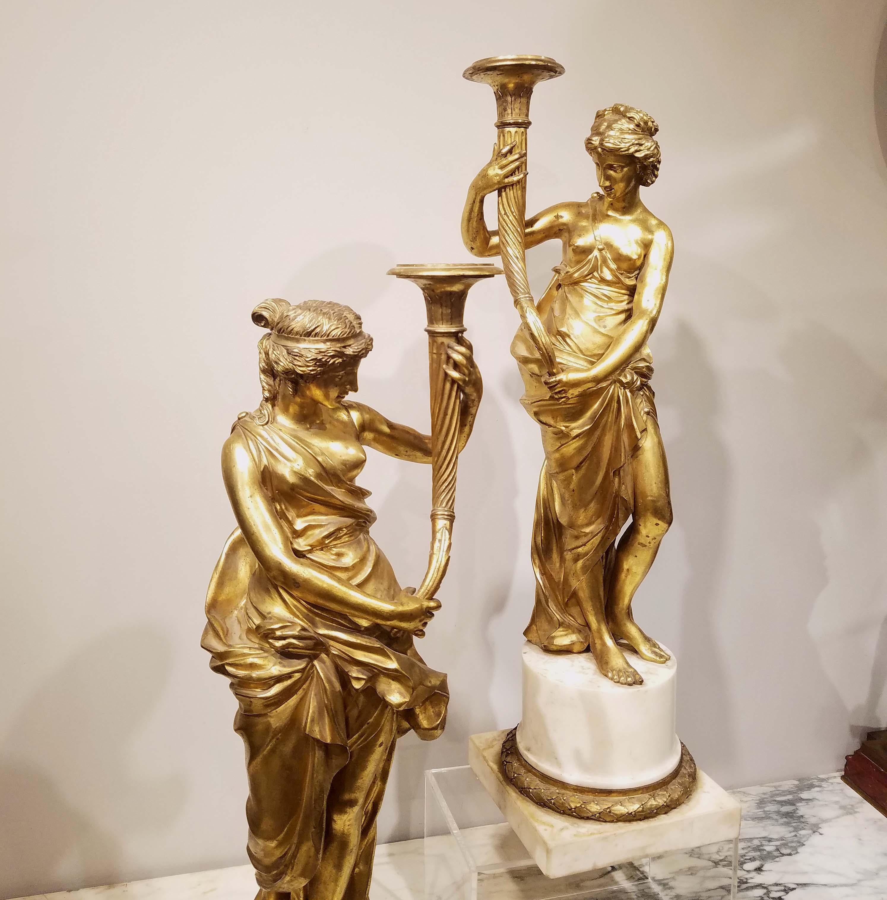 Pair of Louis XVI gilt bronze candelabras. On white marble bases. Great quality with good chasing. Measures: 26.25