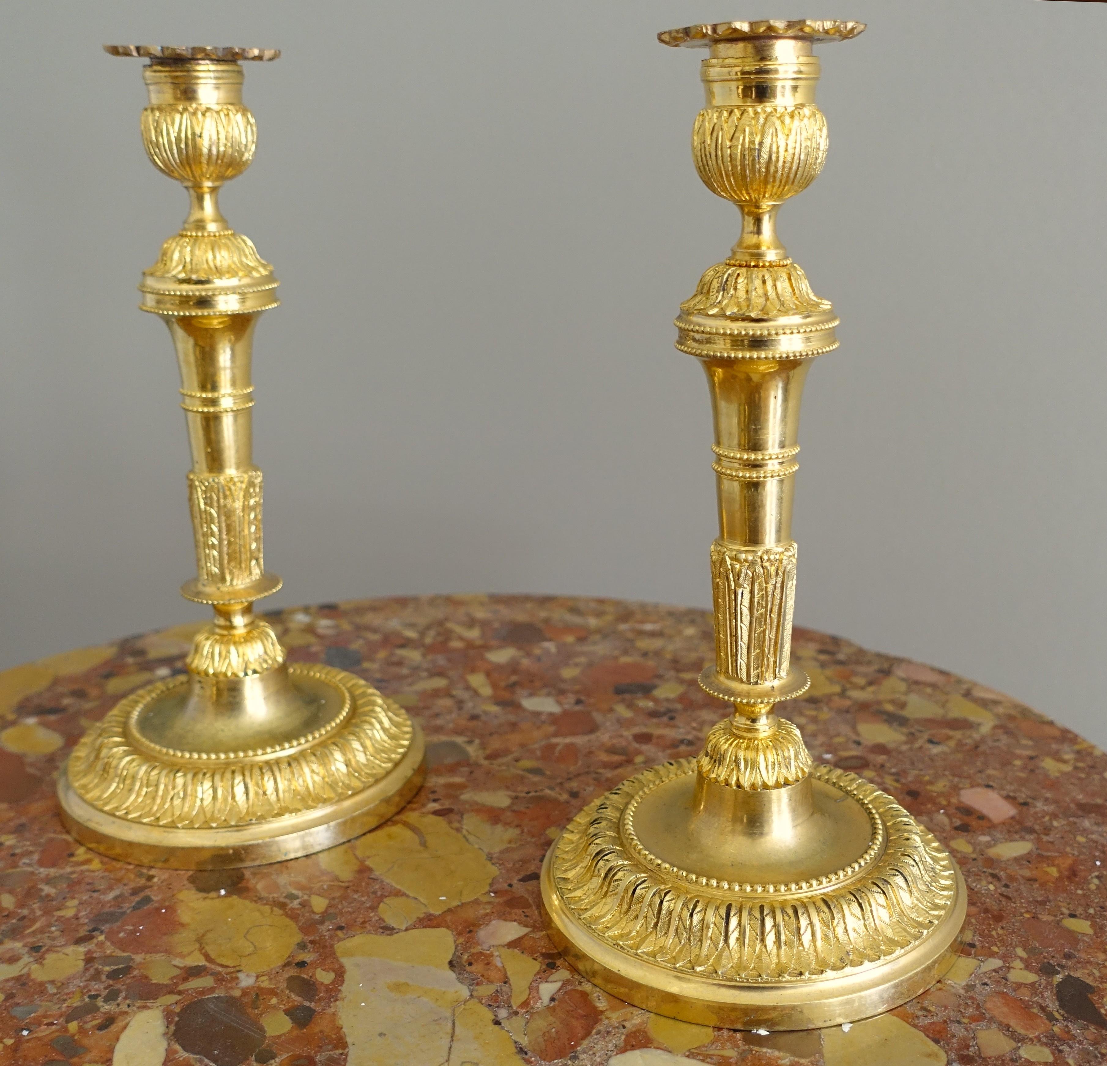 Antiguo par de candelabros franceses, hermosos motivos de estilo Luis XVI finamente cincelados en ormolu (bronce macizo dorado con oro fino). Nuestro modelo está ricamente ornamentado con perlas y acantos.
Nuestros candelabros son una producción de