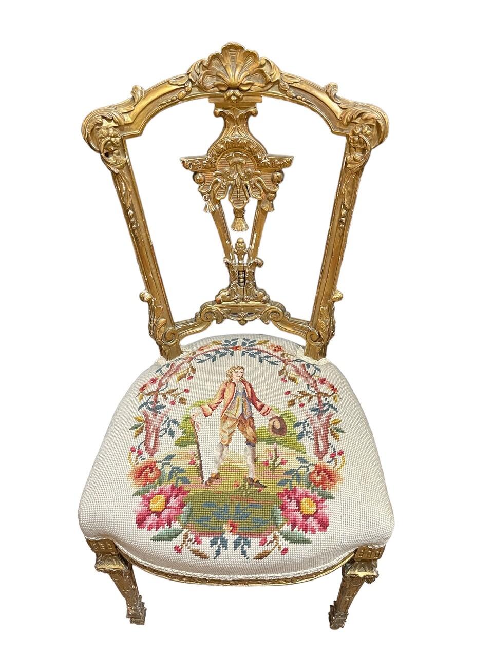 A pair of 19th-century Louis XVI carved giltwood petite ballroom chairs exude elegance with their intricate carving, needlepoint upholstery and gilt finish, epitomizing the opulence of the period.