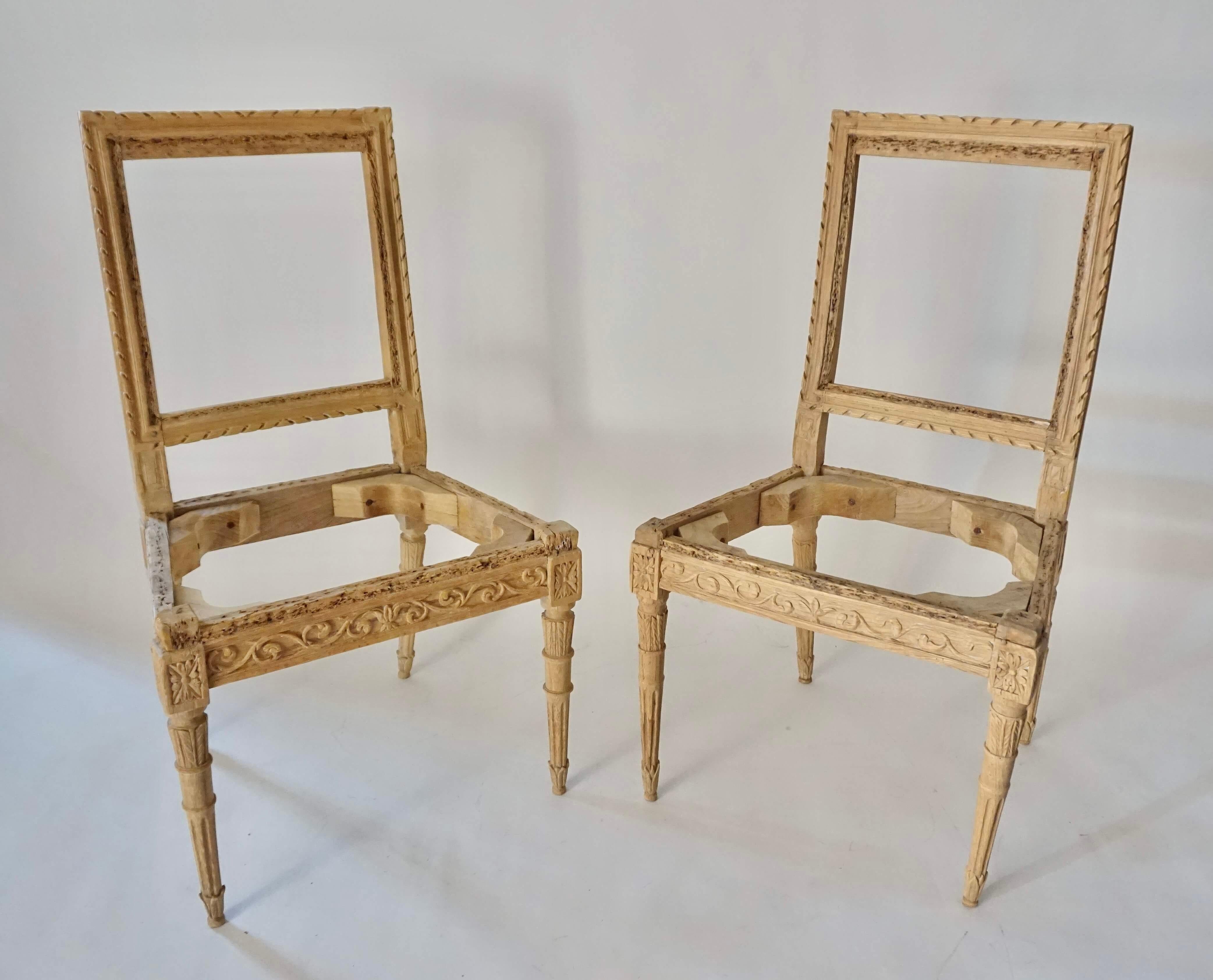 Chic pair of last quarter 18th century Italian neoclassical Louis XVI style side chairs having carved, waxed fruitwood frames; the rectangular backs with twisted-rope borders connecting trapezoidal form seats having foliate rinceau rails on