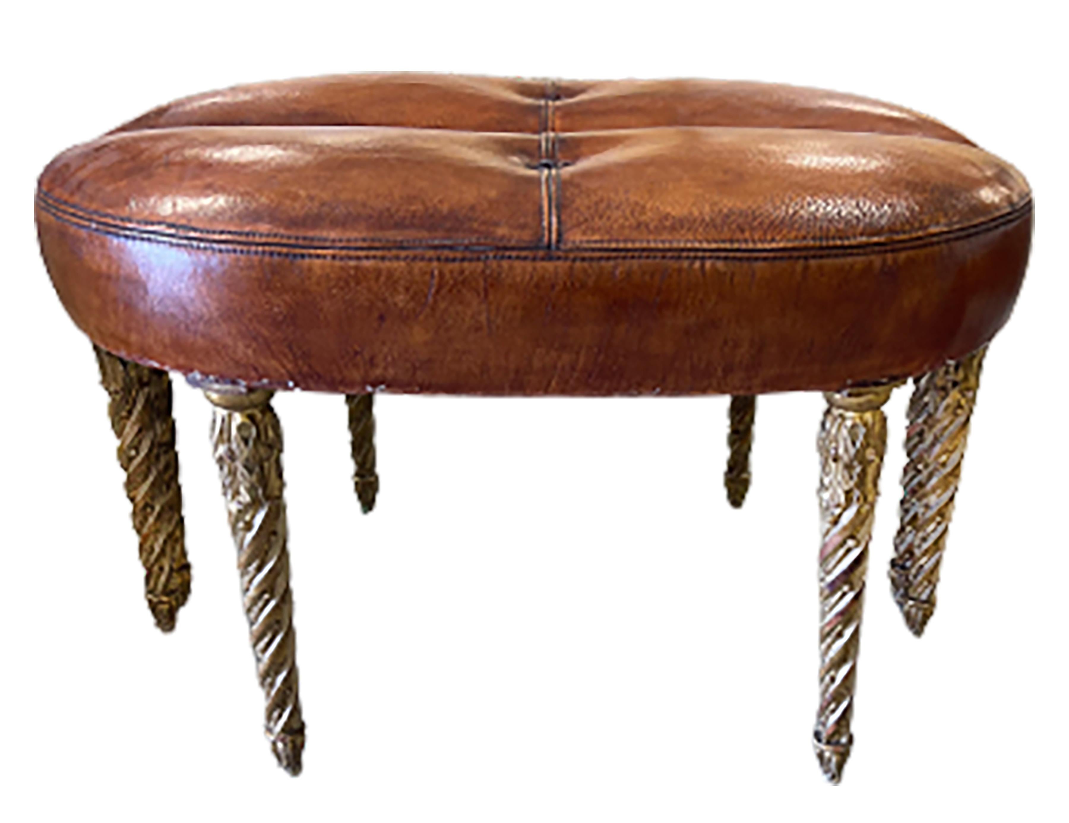 Pair of handsome demi lune vintage Louis XVI leather ottoman stools. Covered in cognac colored leather and tufted in the middle. The gilt wood legs are carved in a spiral design. Paired together the stools form a circle. Structure of the pair was