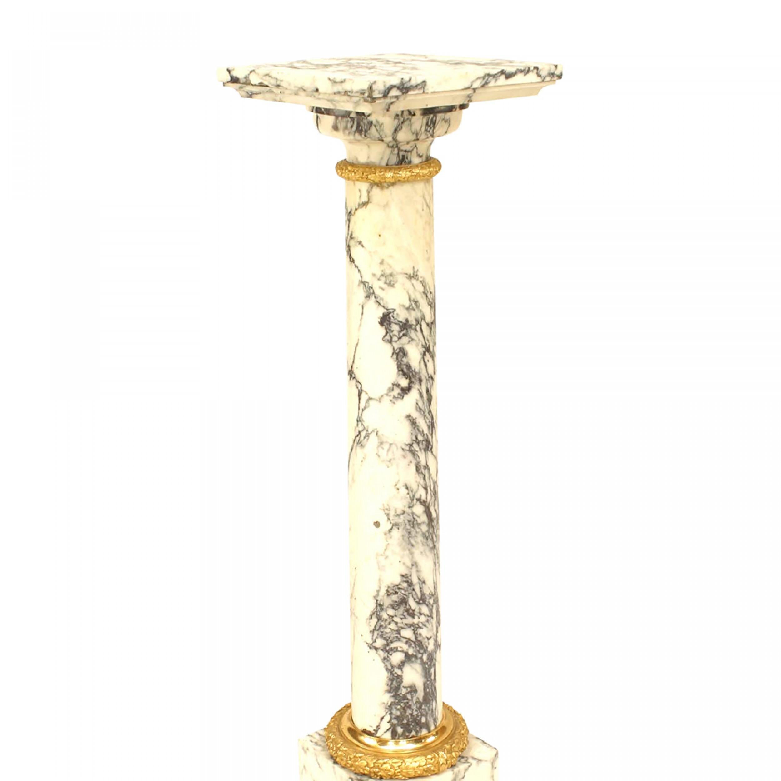 PAIR of Louis XVI style (19th Cent) white and black vein marble pedestals with a cylindrical center between a square top and 2 step square base with gilt bronze trim.