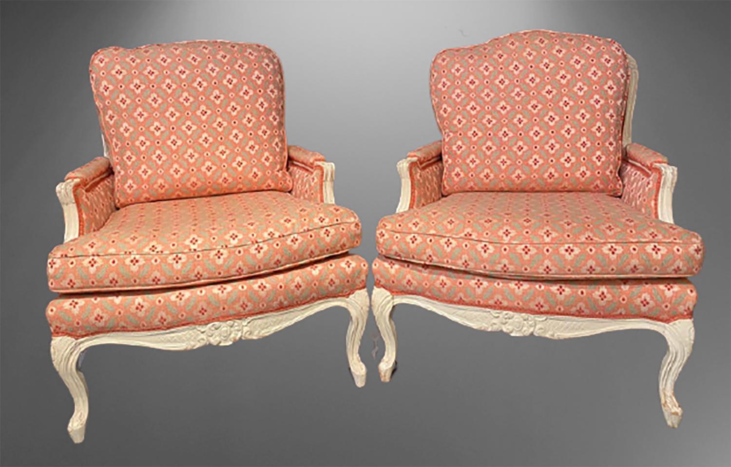 Pair of Louis XVI painted bergère or lounge chairs. Scalamandre upholstery sits on this wonderfully decorative pair of custom arm or lounge chairs. The white painted distressed frames having Louis XV style carved large, wide frames are strong and