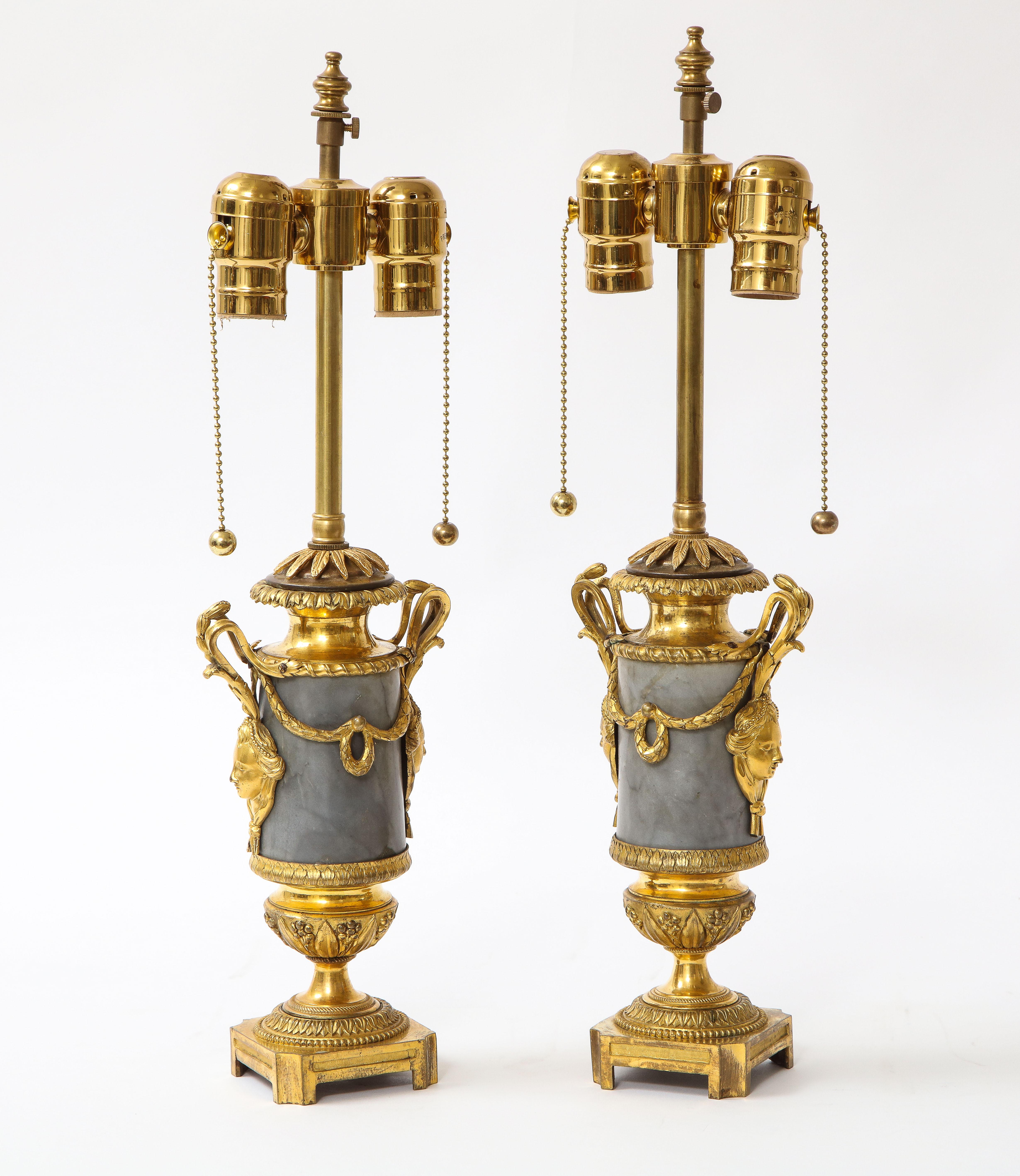 A fine pair of Louis XVI Period Dore bronze mounted grey and black veined marble vases turned to lamps. Each is beautifully made with a cylindrical hand-carved grey and black veined marble body with exceptional dore bronze mounts which are each