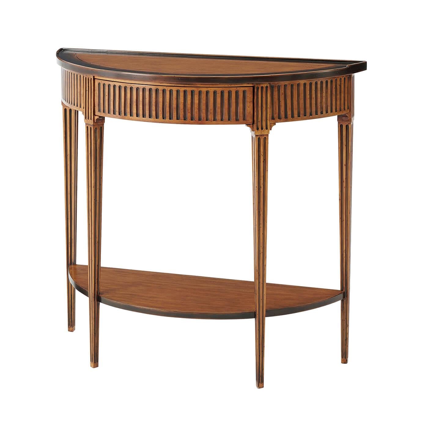 A Louis XVI style rustic honey finish console table, the bowfront gallery top with an ebonized edge, above a fluted frieze and drawer, on square fluted legs, joined by an under tier. 

Dimensions: 38