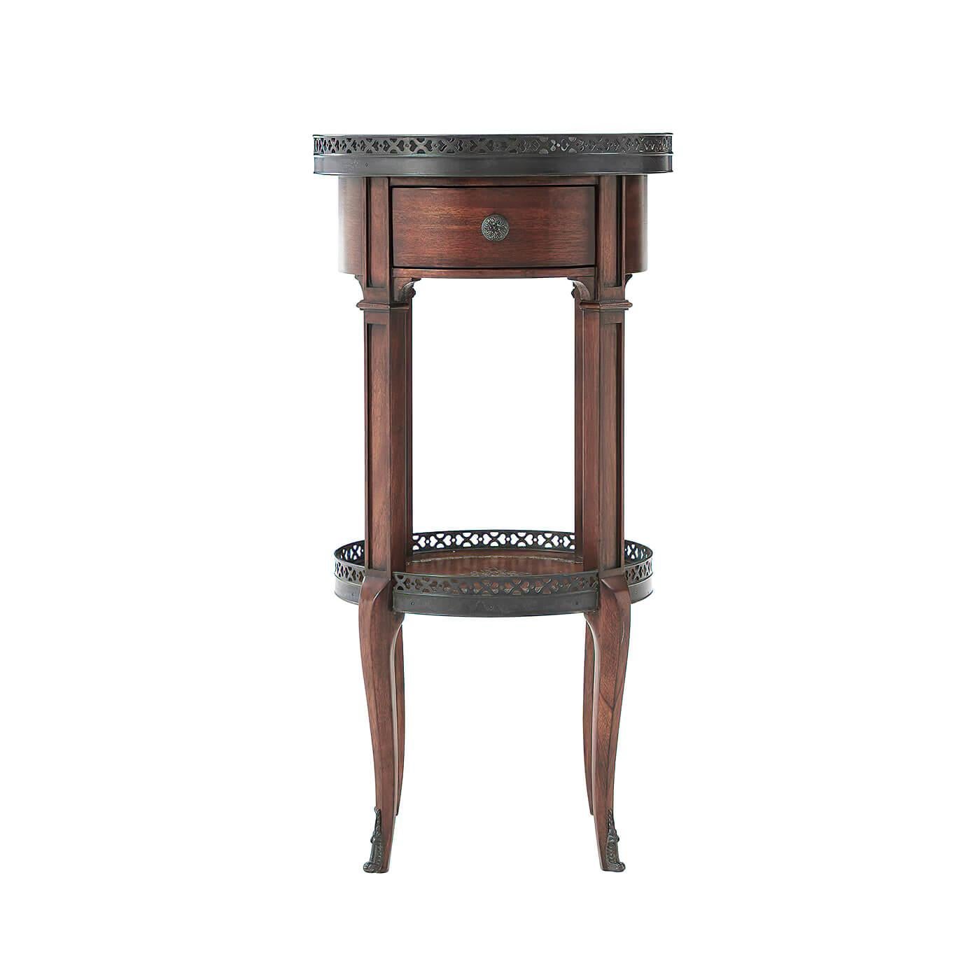 A French Louis XVI style circular end table, with brass gallery, tooled brown leather top and undertier, frieze drawer, on square and cabriole legs. 

Dimensions: 13.75