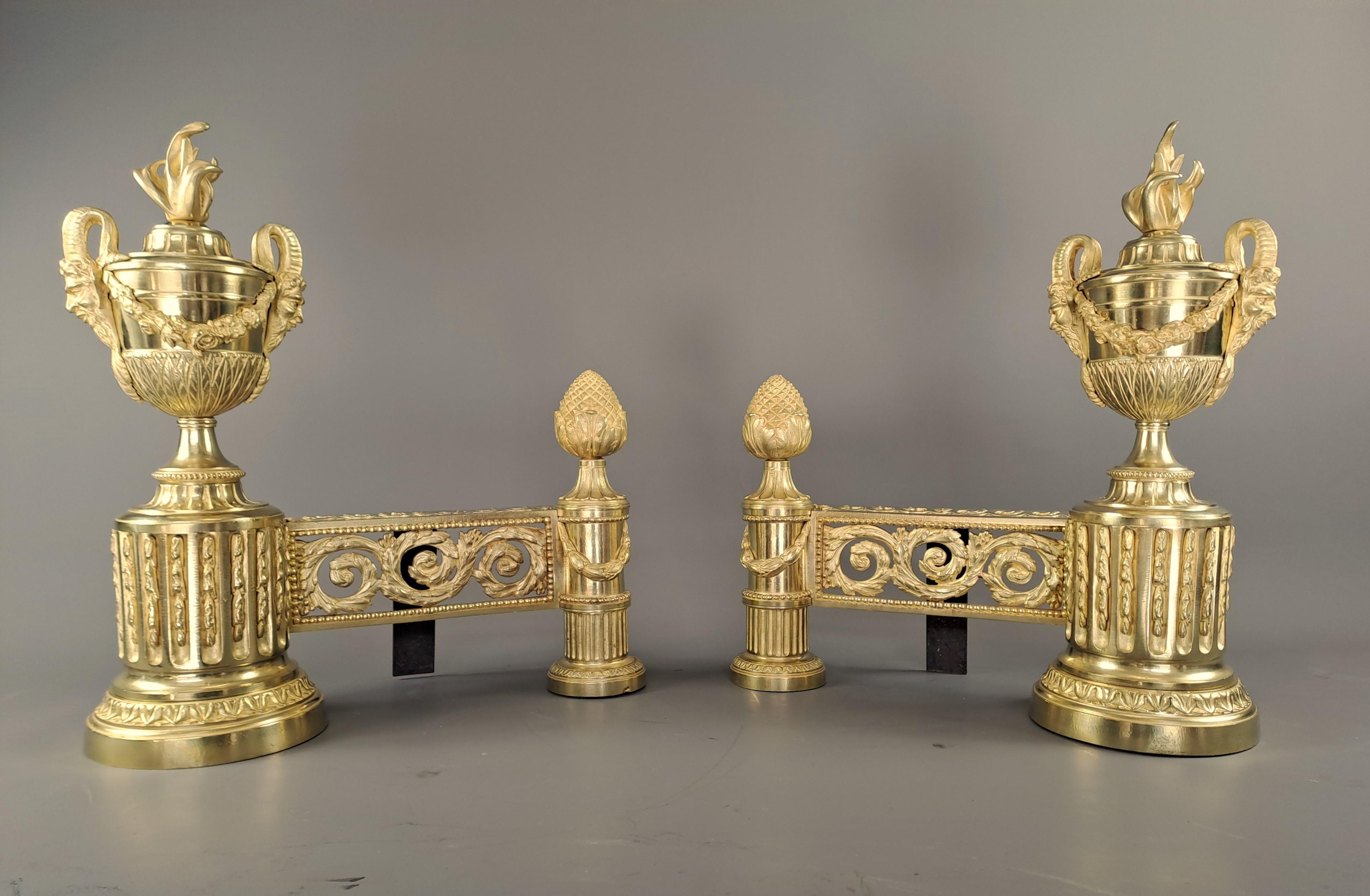 Superb pair of Louis XVI style andirons in very finely chiseled gilded bronze.

Prestigious model presenting a central band composed of openwork scrollwork on the front and a frieze of scrolls on the top, two cylindrical bases support this central