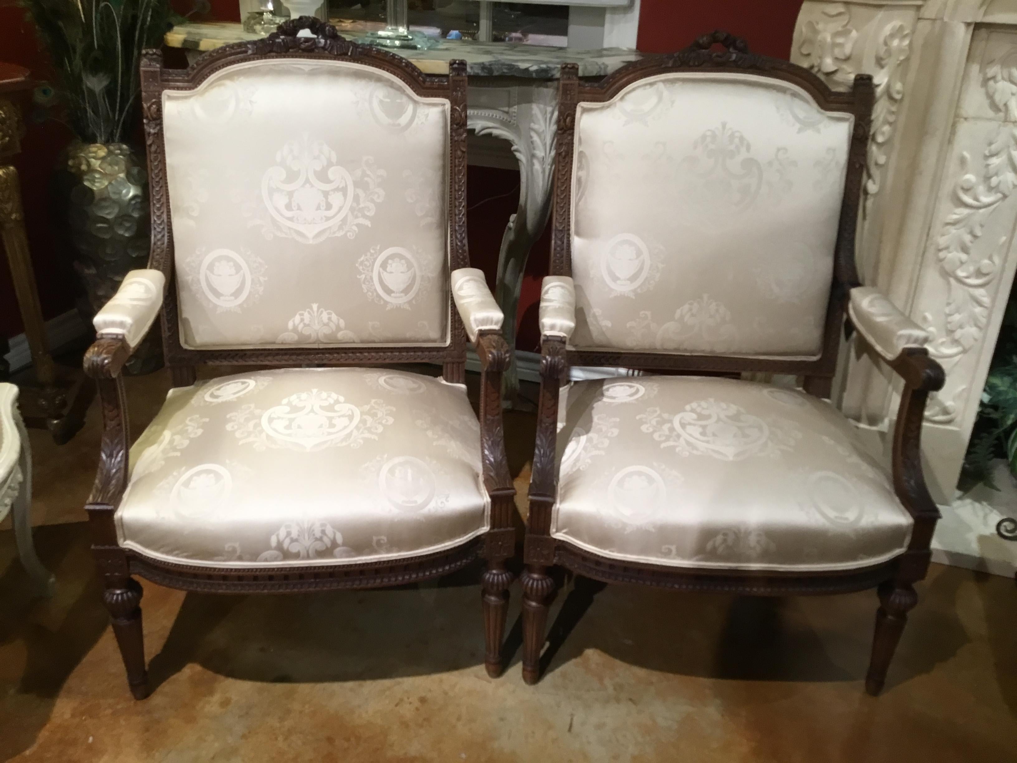 Excellent pair of armchairs in the Louis XVI style with lovely new white silk
Upholstery having a reeded leg and a graceful arm.