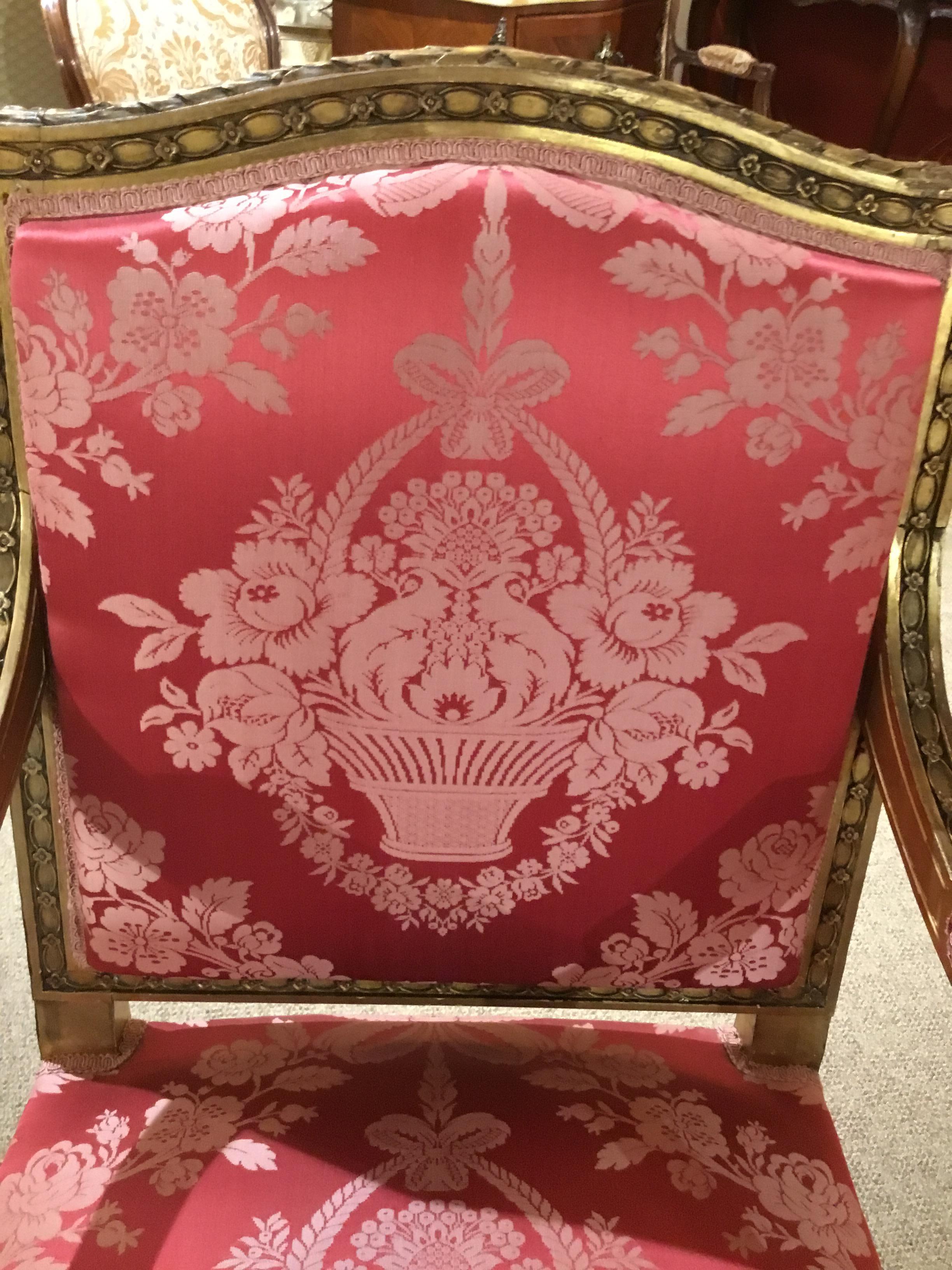 Lovely pair of Louis XVI style armchairs with square back with slight oval at the center back. The gilt finish in soft gold patina.
Upholstered in silk rose damask. Fabric without spots or problems. The front
Legs have a squared tapered leg with a