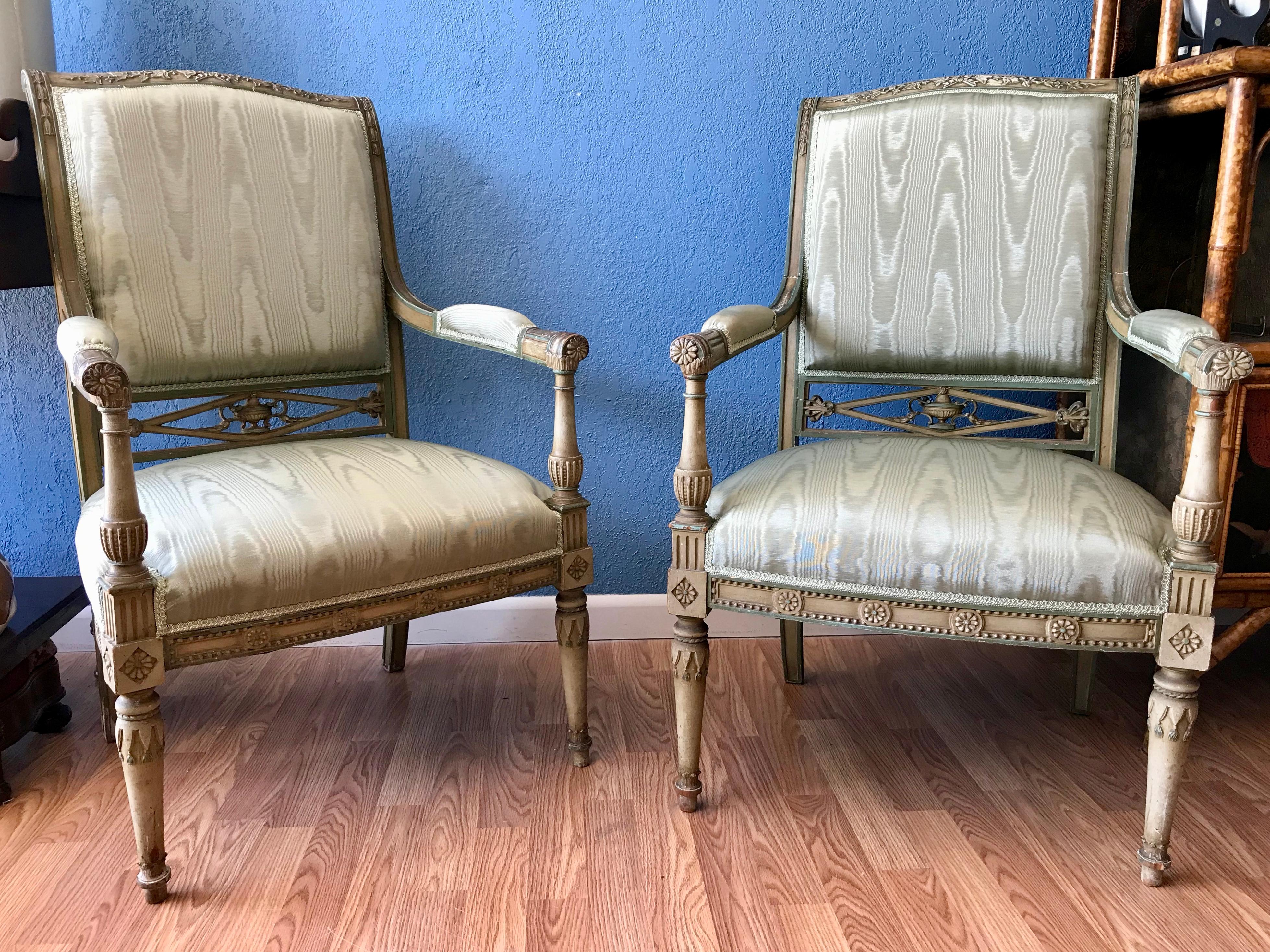 The chairs are accented with striking carving.
They are finished with a pale green wash and richly upholstered with silk moire'.
A beautiful Continental pair.