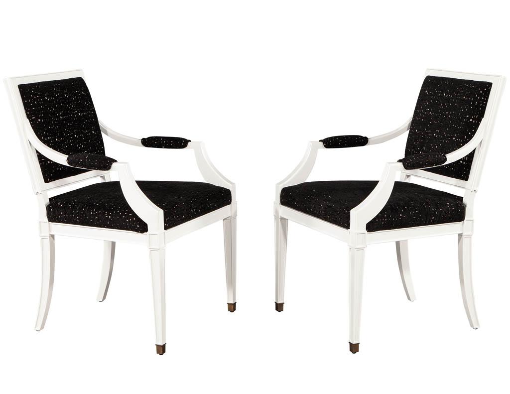 Pair of Louis XVI style arm chairs in black and white. Finished in a designer white lacquer and upholstered in a designer black pin dot fabric. Price includes complimentary curb side delivery to the continental USA.