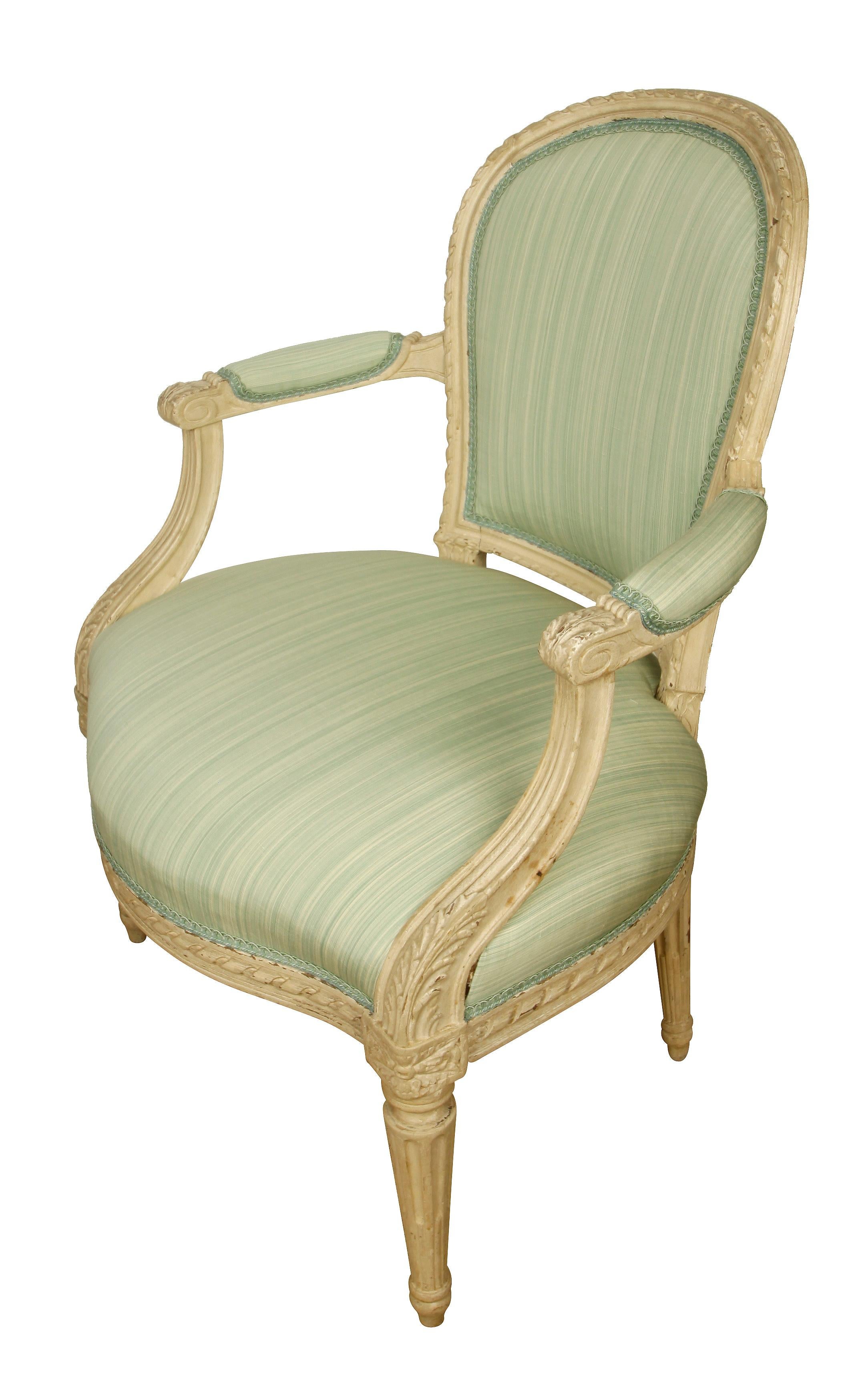 A pair of Louis XVI style armchairs circa 1930 newly upholstered in an aqua silk stripe fabric. Seat backs upholstered in a coordinating aqua silk check.