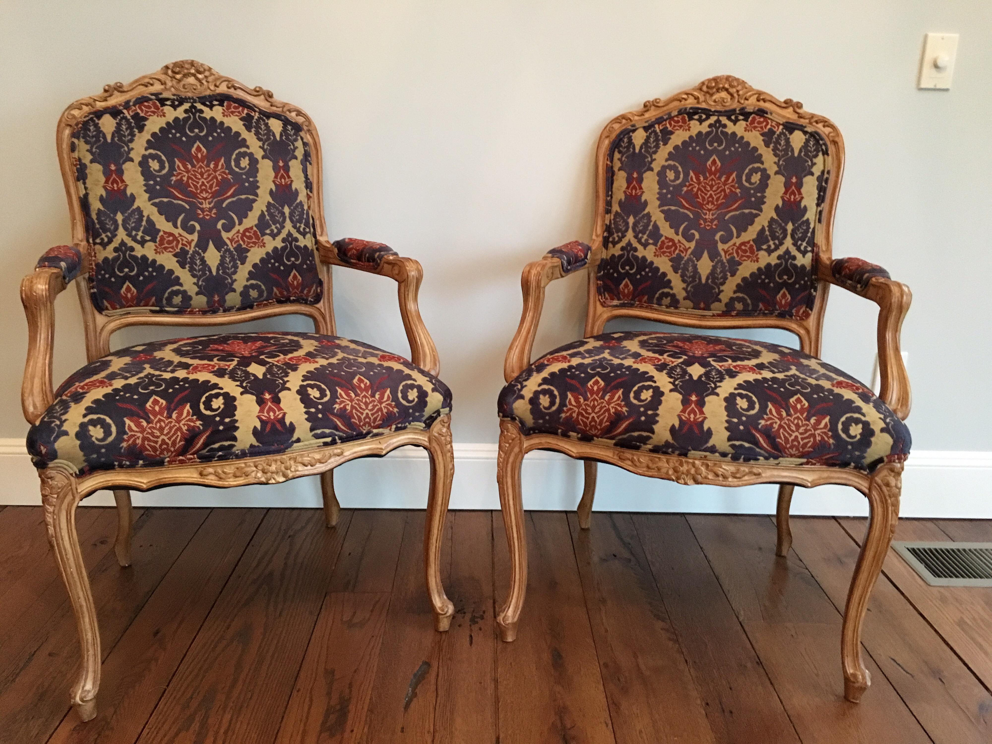 Pair of Louis XVI style armchairs covered in cut velvet fabric. Carved foliage and shell motif at the top. Very good condition. Two small ink stains on seat of one chair.