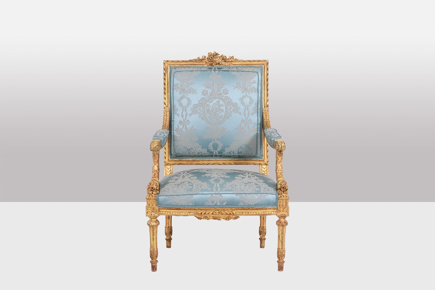 Wood Pair of Louis XVI style armchairs in gilded and carved wood. Circa 1880.