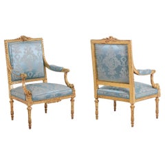 Antique Pair of Louis XVI style armchairs in gilded and carved wood. Circa 1880.