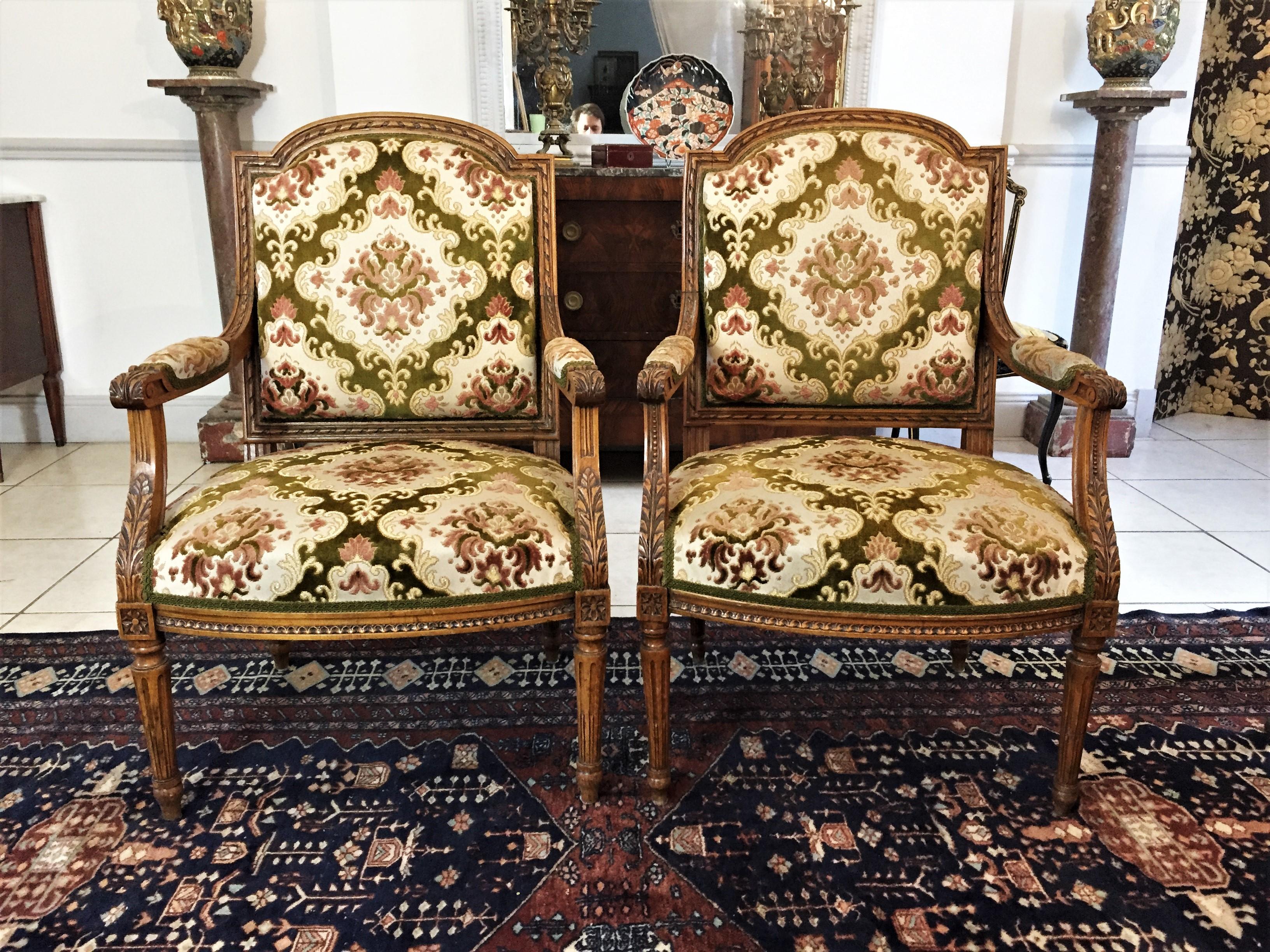 Beautiful pair of Louis XVI style armchair, fluted and rudenté base, frieze belt, carved backrest with basket handle, pearls and ribbons, the armrests decorated with acanthus leaves, ending in winding. The pair is furnished with its original fabrics