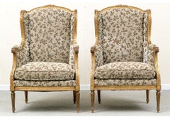Pair Of Louis XVI Style Bergeres In A Carved Gilt Finish