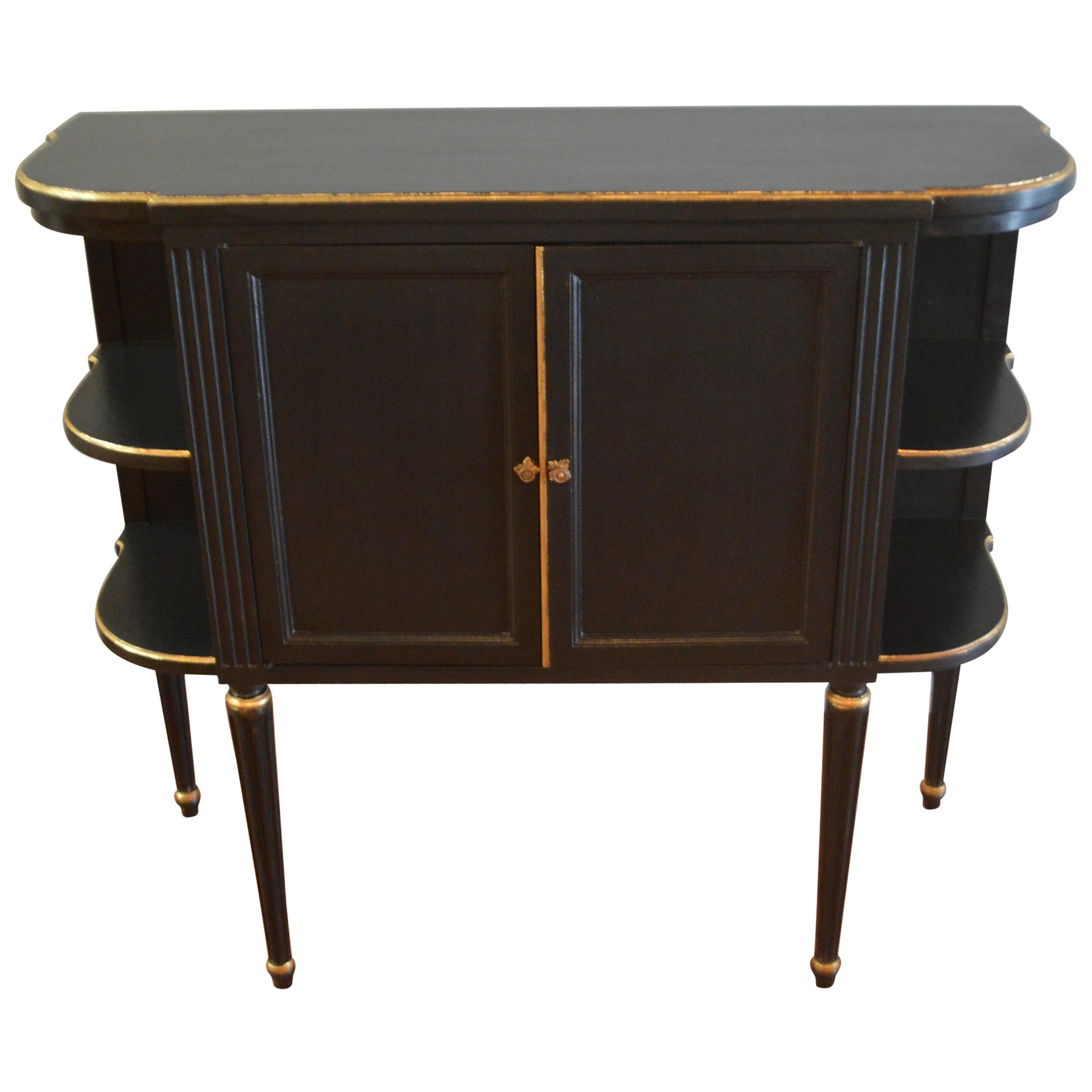 Attractive and unusual black cabinets with some gilt accents, two doors middle compartment with shelf and open shelves at sides.
These cabinets would make great bedside tables as well as serving table.