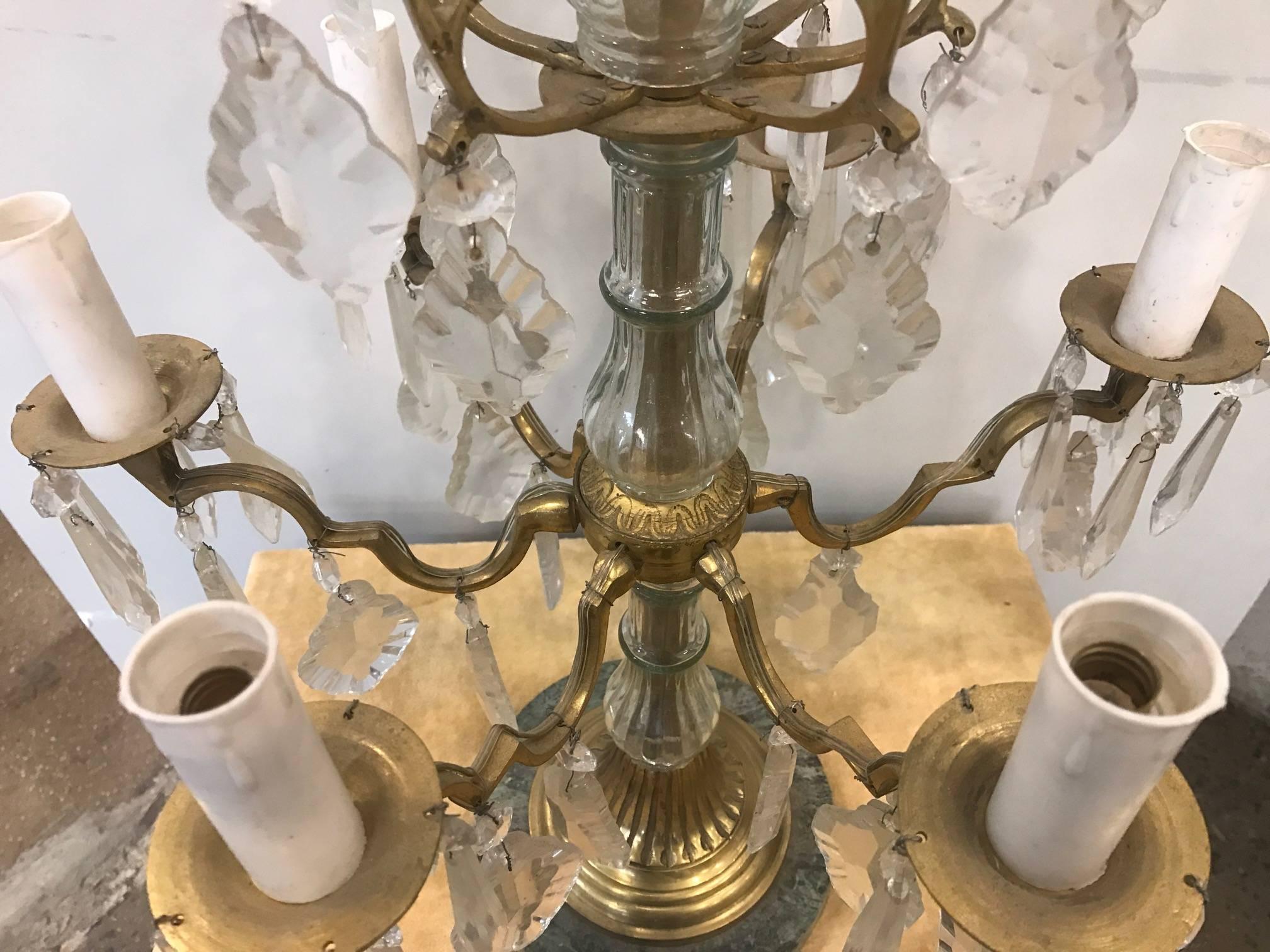 Pair of Louis XVI style six-light candelabras, crystal prisms with a marble bases.