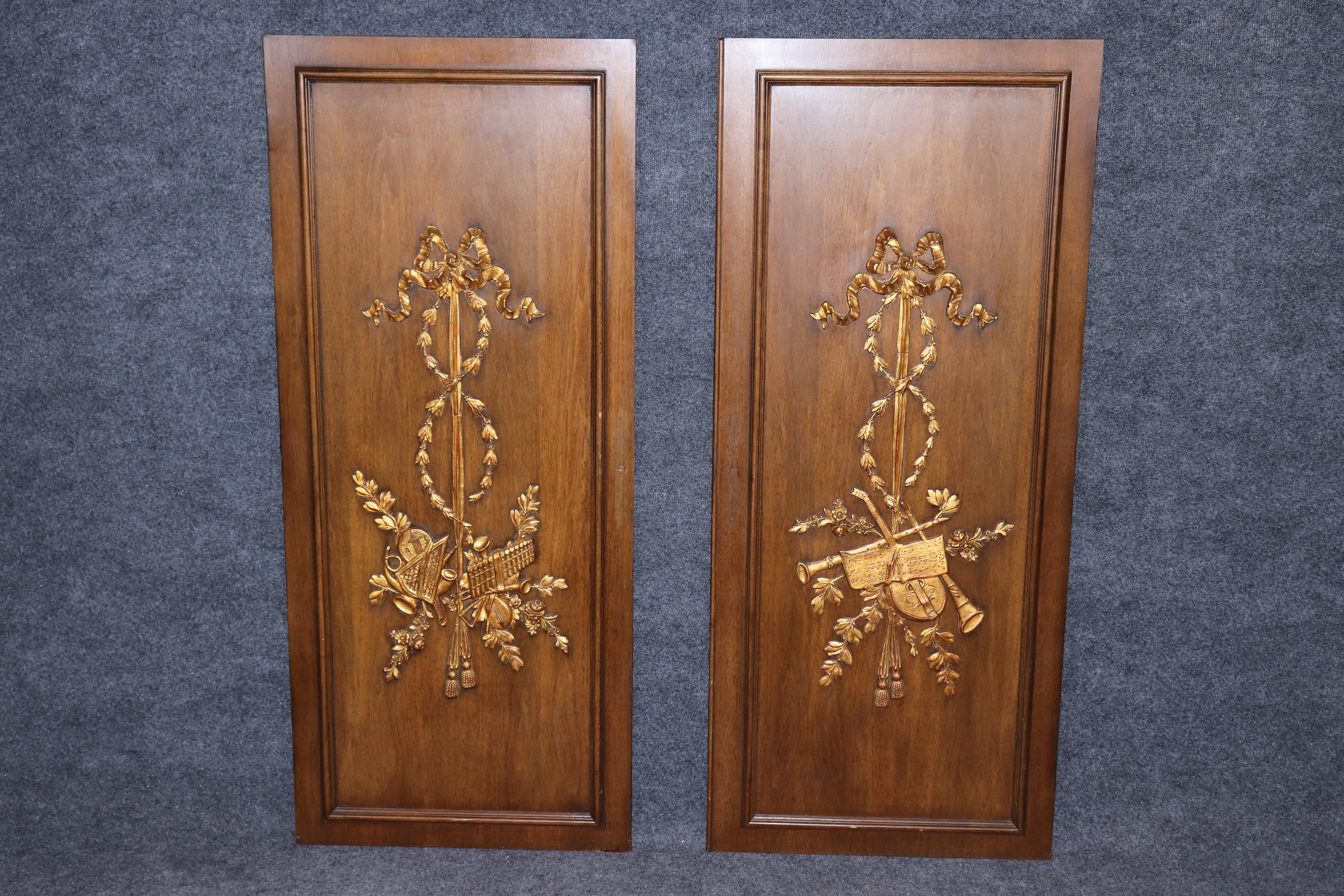 Dimensions - H: 57 1/2 in W: 24 3/4 in D: 1 in 

Elevate your interior with this stunning pair of 20th-century Louis XVI style carved wood and gilt accent wall panels, exquisitely crafted to capture the timeless beauty and refined grandeur of
