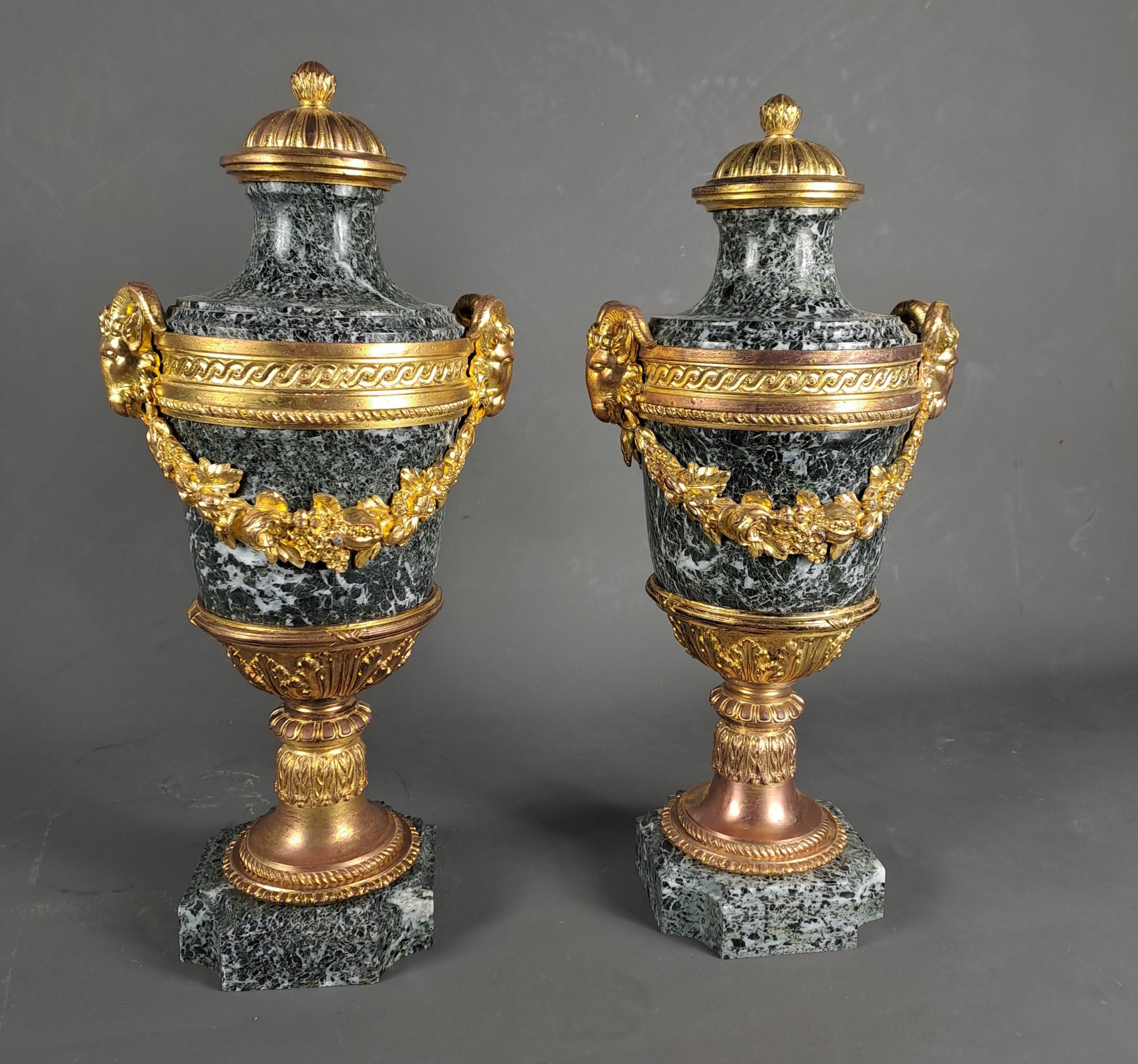 Pair of Louis XVI style cassolettes in sea green marble and beautiful gilded and chiseled bronze ornamentation decorated with rams' heads and floral garlands.

After a model by Henry Dasson

Good condition, some wear to the gilding