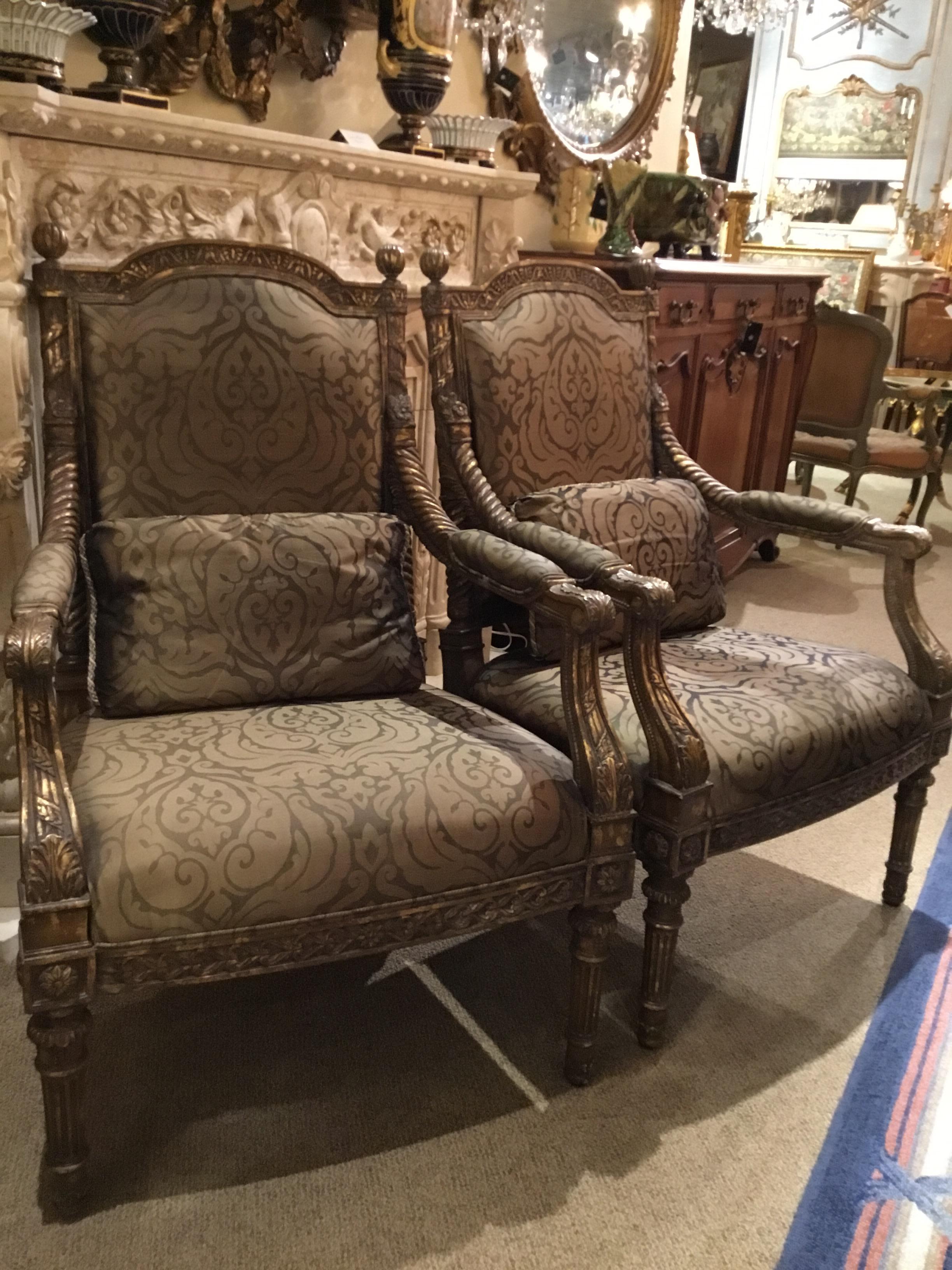 Handsome and comfortable pair of Louis XVI style chairs with a faux
gilt finish. Having a reeded leg and dome shaped seat back.
Two cushions come with this set.